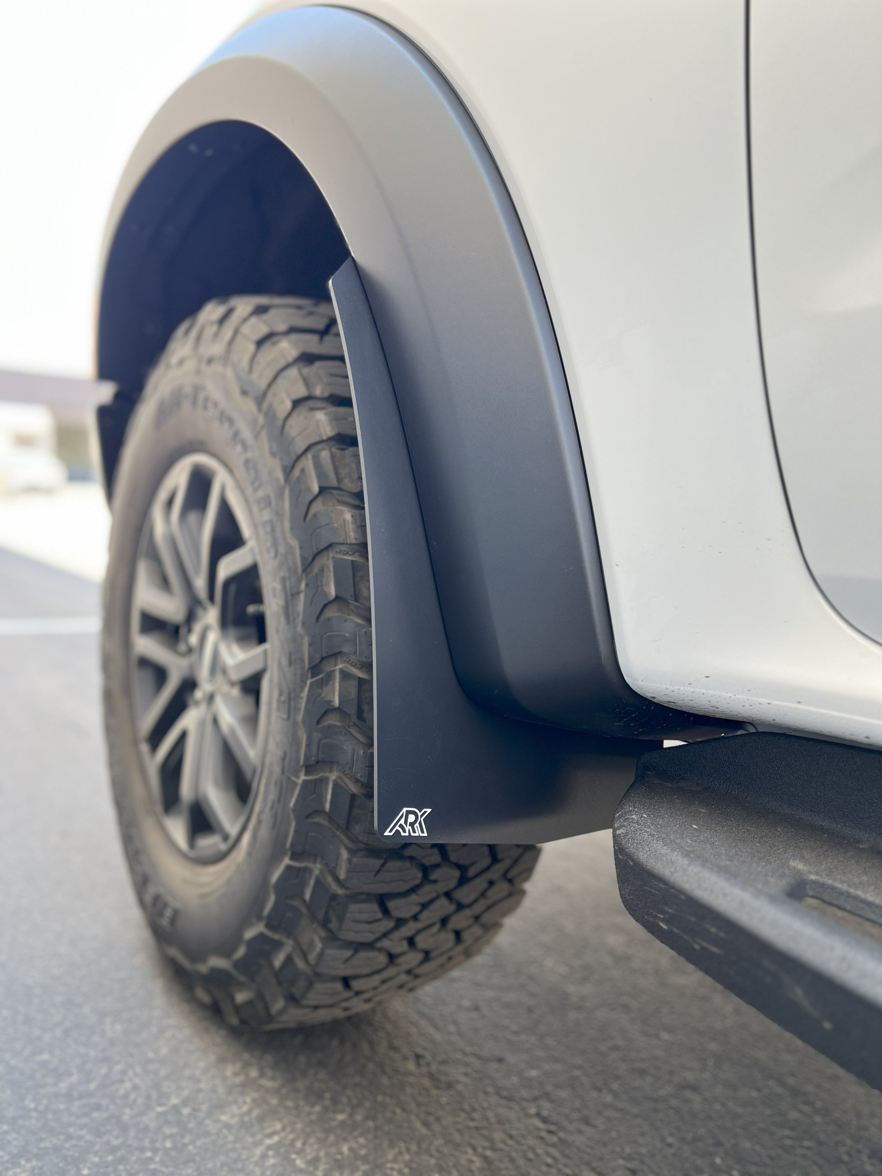 2024+ Ford Ranger Raptor TriXPoly Mid Mud Flaps installed on a vehicle, showcasing rugged design and tire protection.