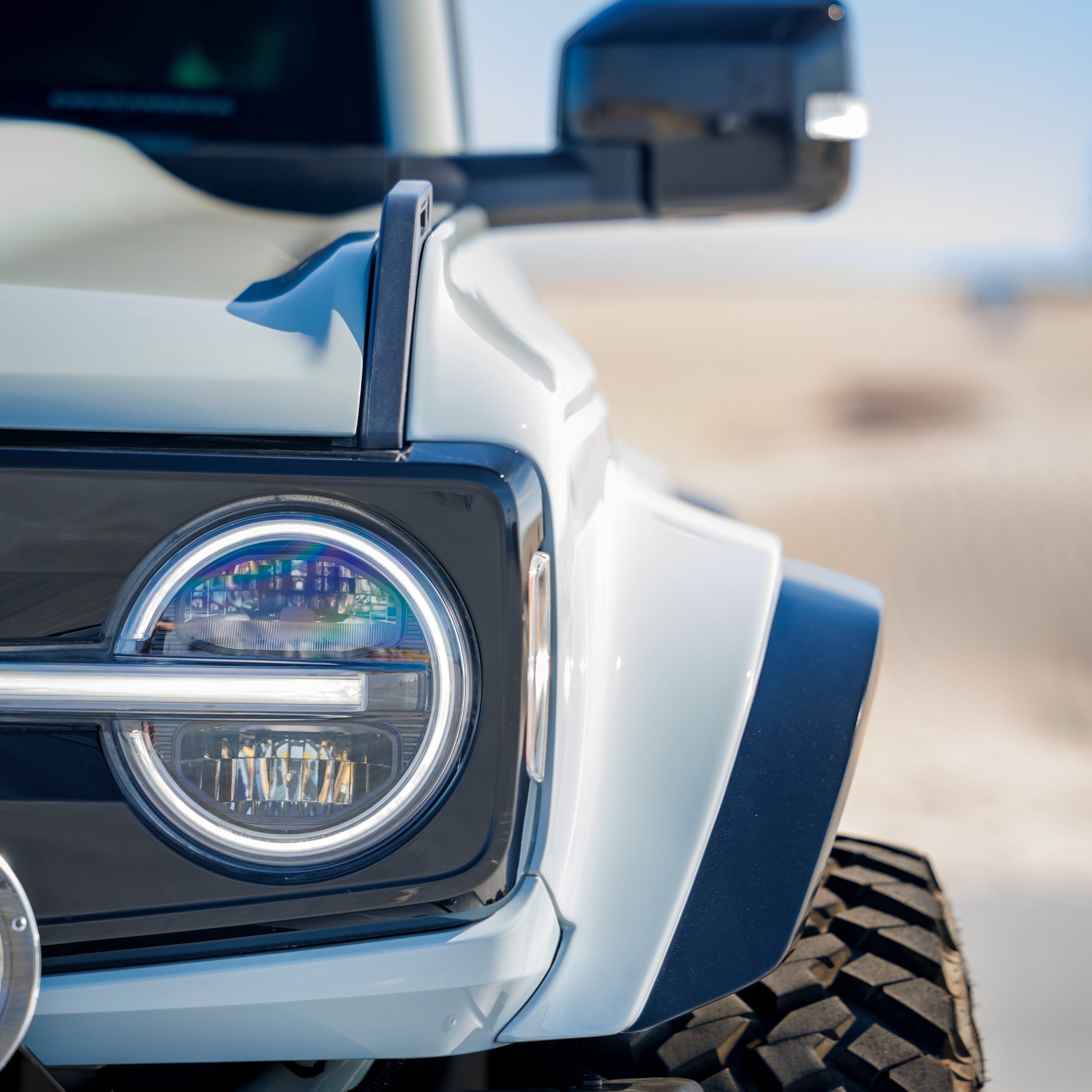 Close-up of a 2021-2025 Ford Bronco fender showcasing its rugged design and integrated headlight, perfect for offroad enthusiasts.