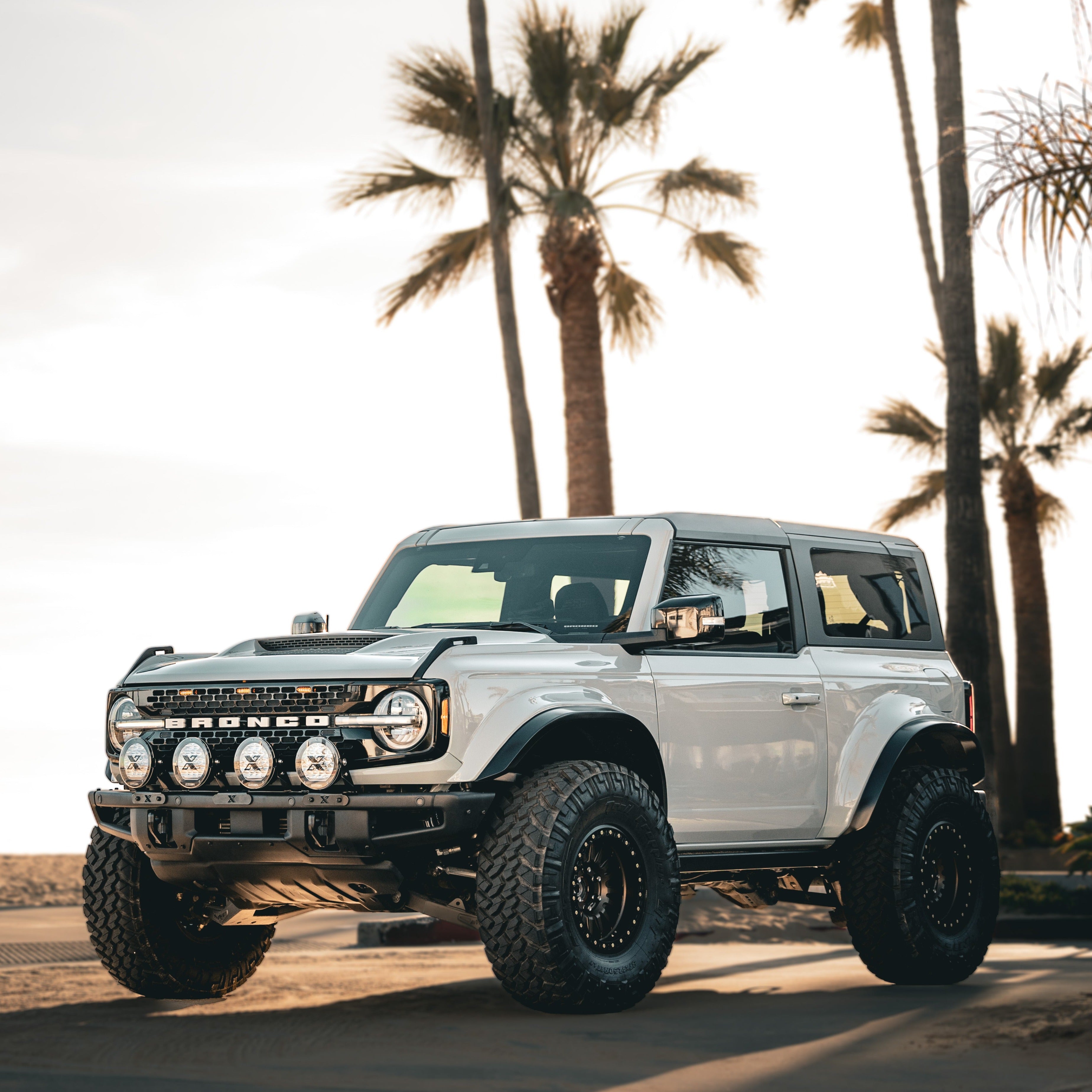 2021-2025 Ford Bronco 2-Door Rear Quarter Kit installed on a modified Bronco parked near palm trees.