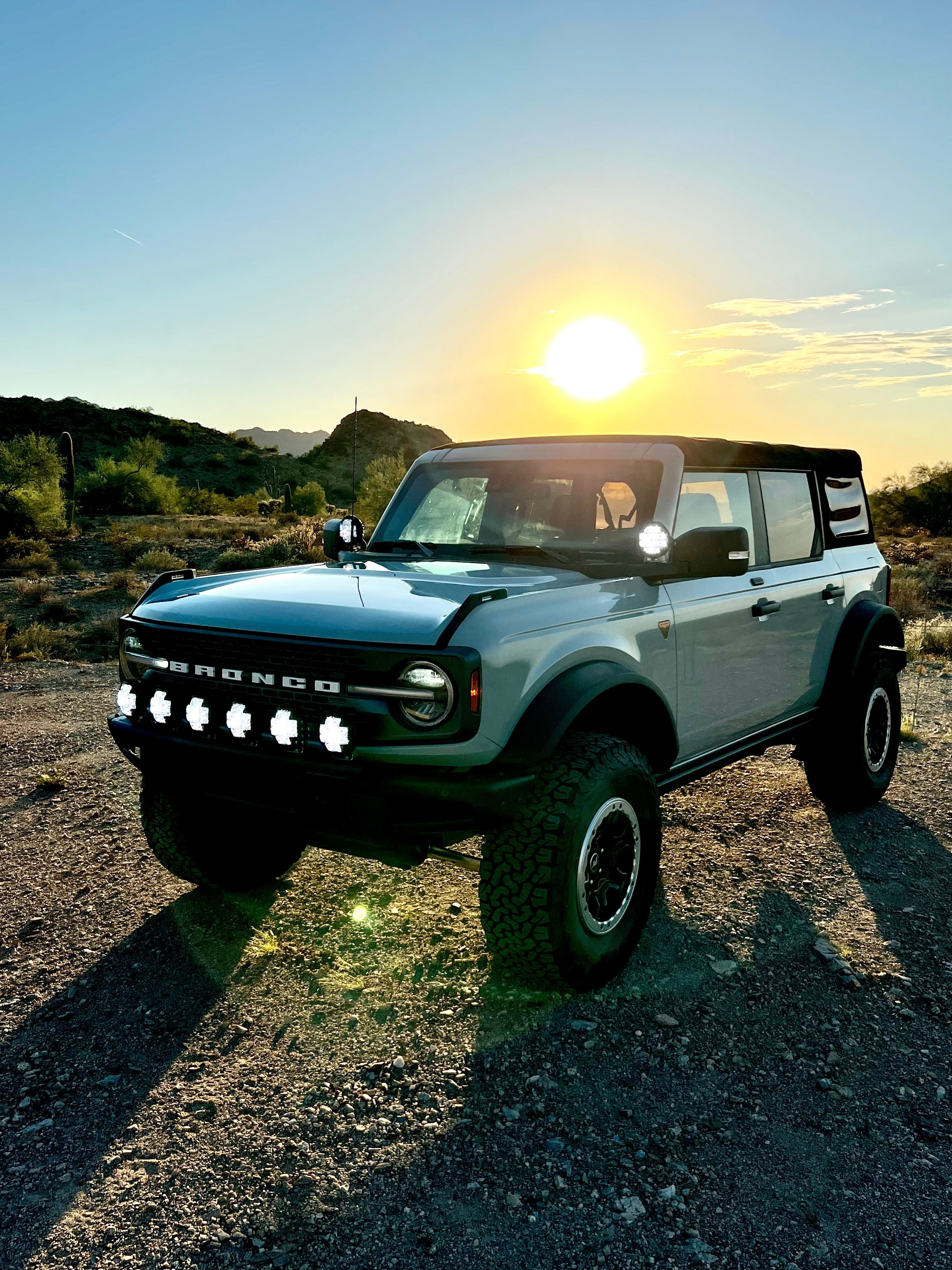 2022-UP Bronco Raptor Front Light Mount Kit showcasing a Bronco with multiple lights installed, set against a sunset backdrop.