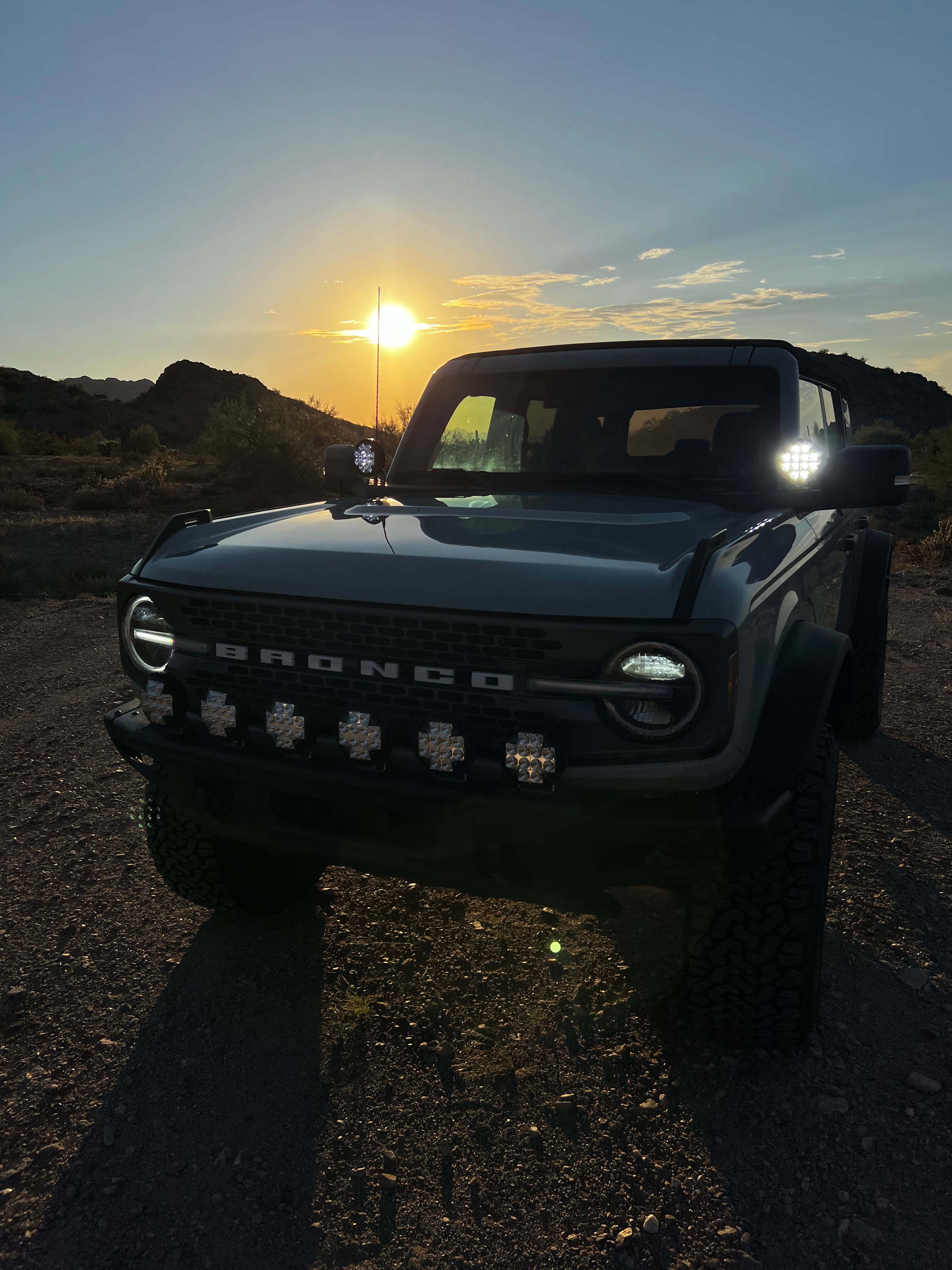 2022-UP Bronco Raptor with front light mount kit showcasing customizable lights against a sunset backdrop.