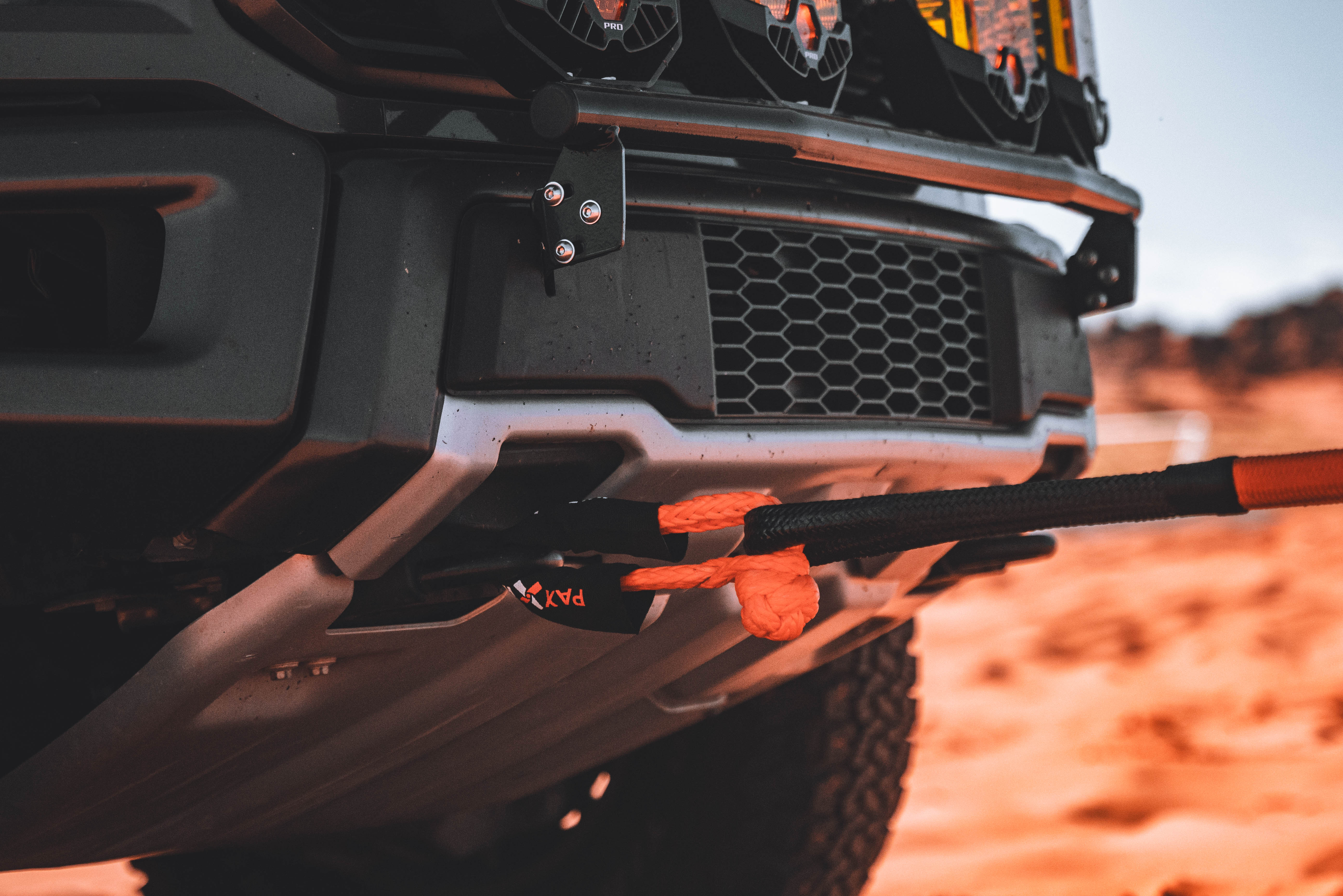 1/2 inch soft shackle attached to a truck's front bumper, showcasing its strength and versatility for offroad recovery.