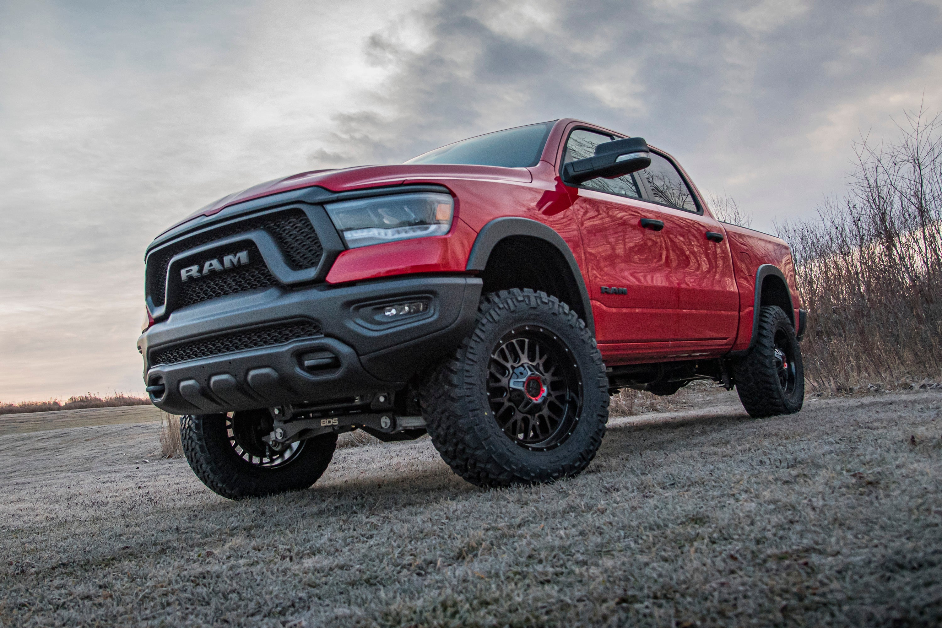 4-inch lift kit for Ram 1500 Rebel (2019-2024) 4WD showcased on a lifted red truck in an outdoor setting.