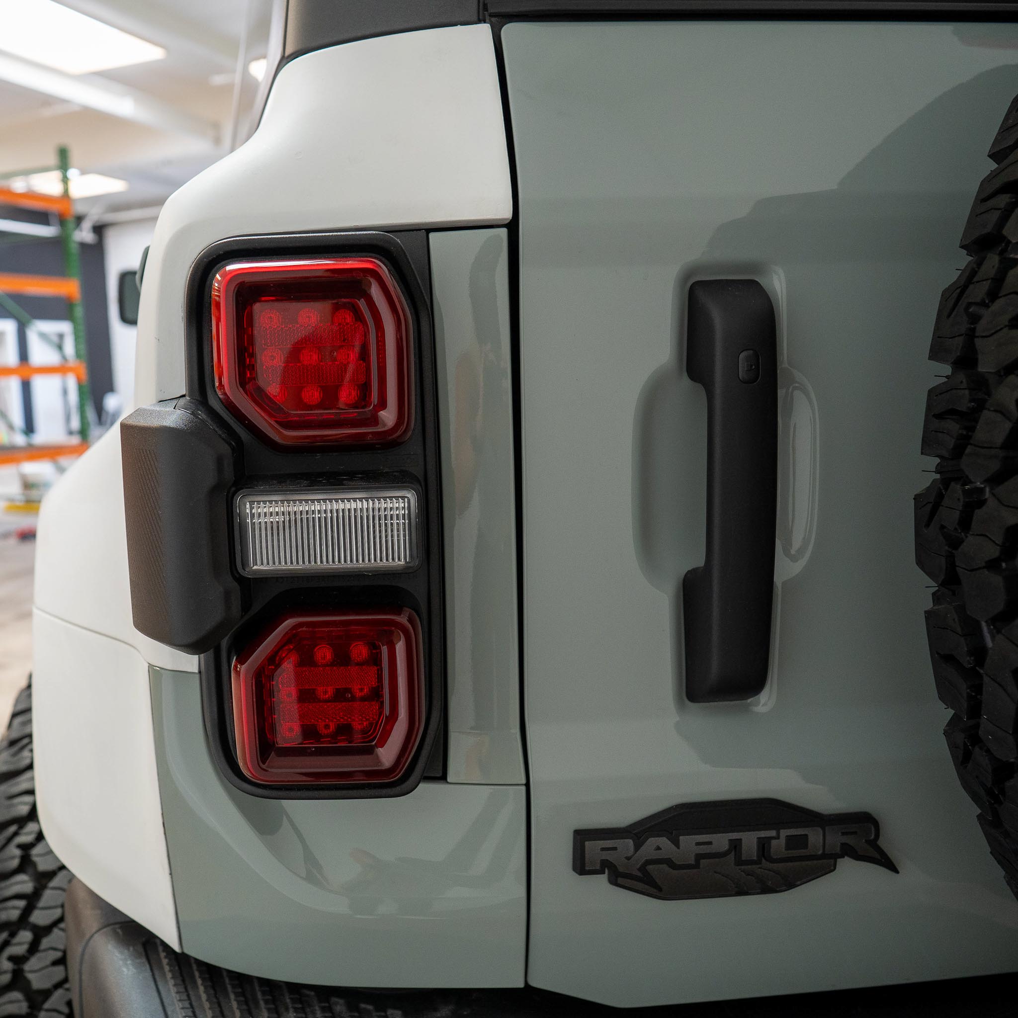 2022-2025 Ford Bronco Raptor rear quarter kit showcasing taillights and Raptor branding for enhanced offroad style.