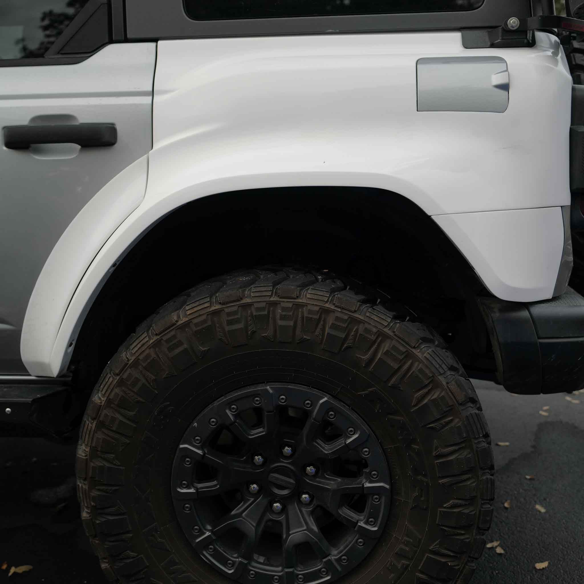 2022-2025 Ford Bronco Raptor rear quarter kit showcasing a rugged design and large off-road tire for enhanced performance.