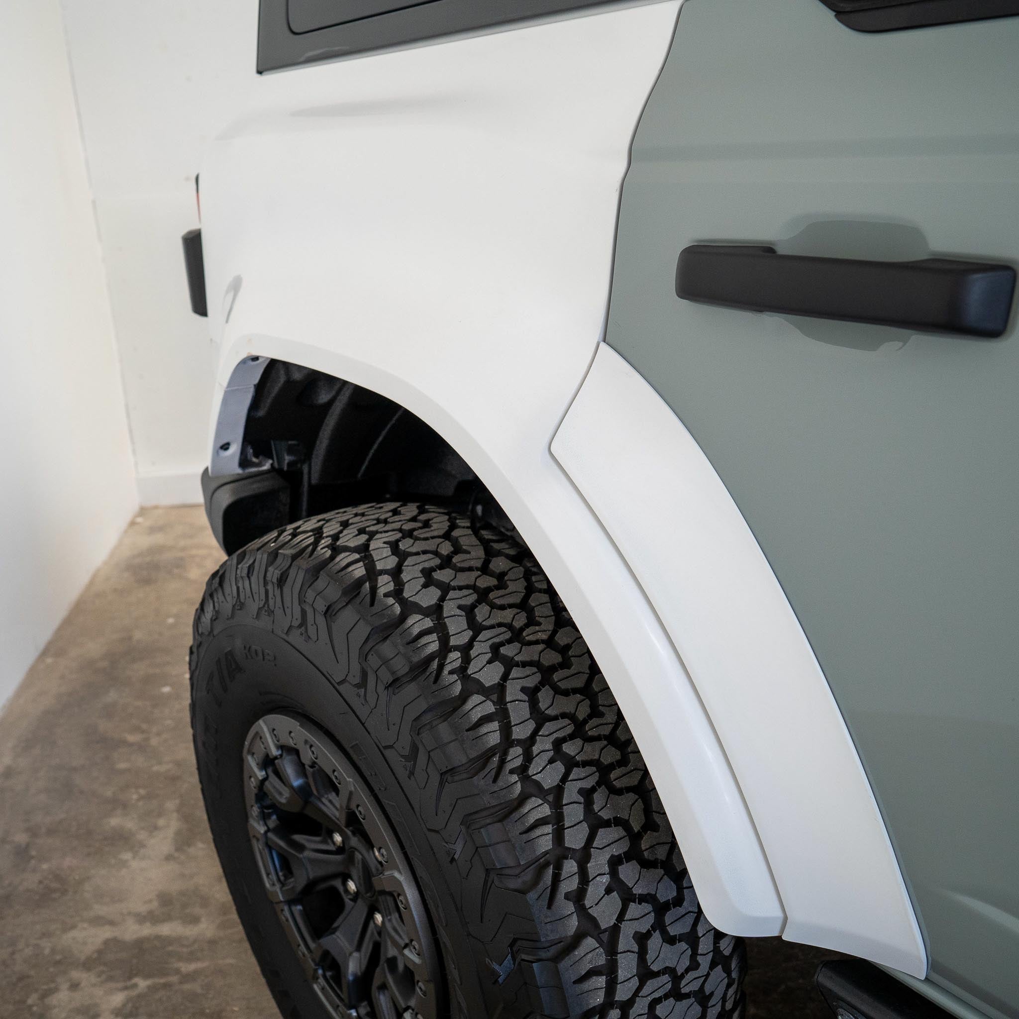 2022-2025 Ford Bronco Raptor rear quarter kit showcasing a rugged design and durable tire tread for offroad performance.