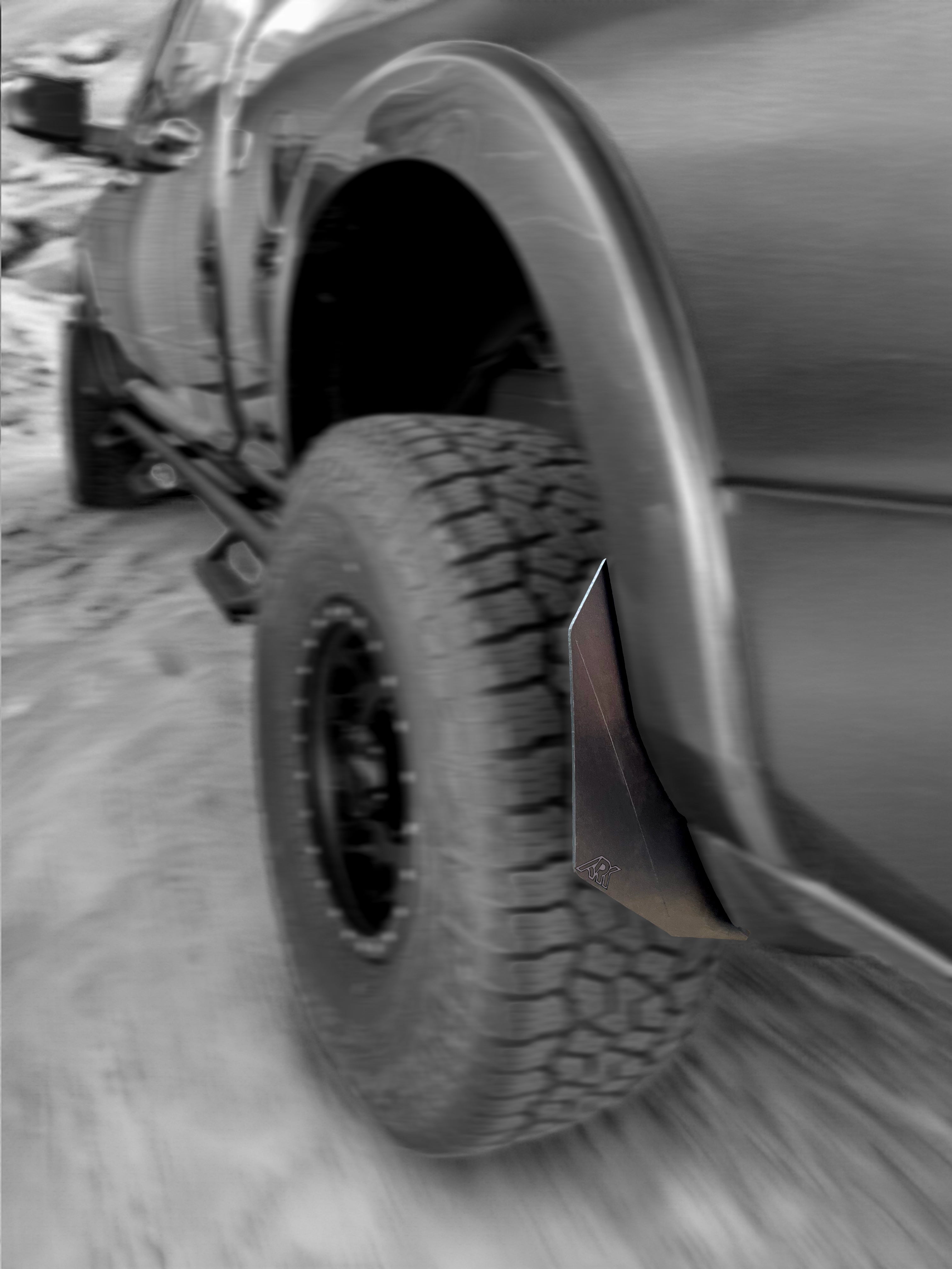 Dodge RAM TriXpoly Micro Splash Guards installed on a 2009-2024 RAM truck tire, providing protection from mud and debris.