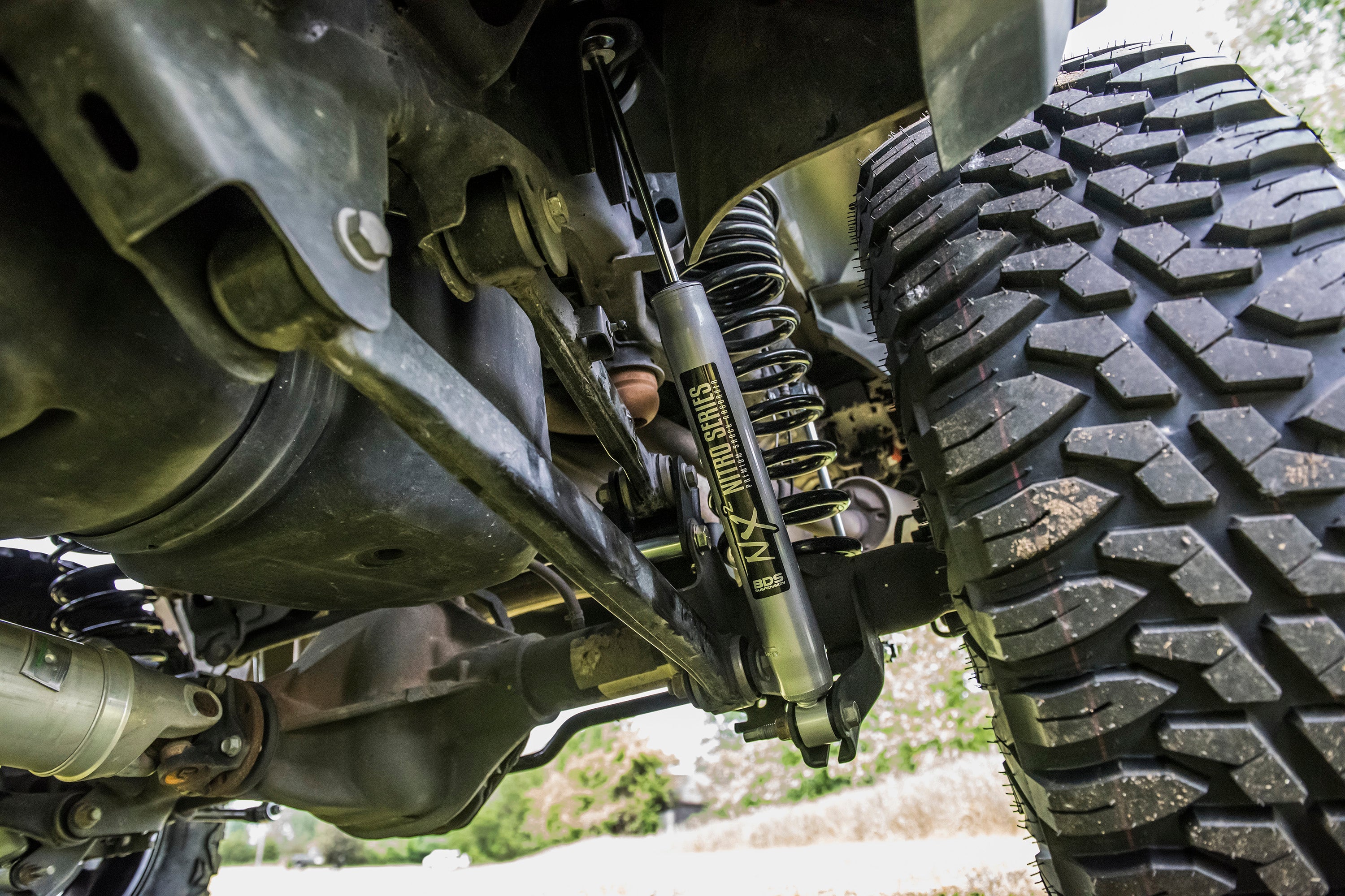 4-inch lift kit for Ram 1500 4WD (2019-2024) showcasing suspension components and rugged tire tread.
