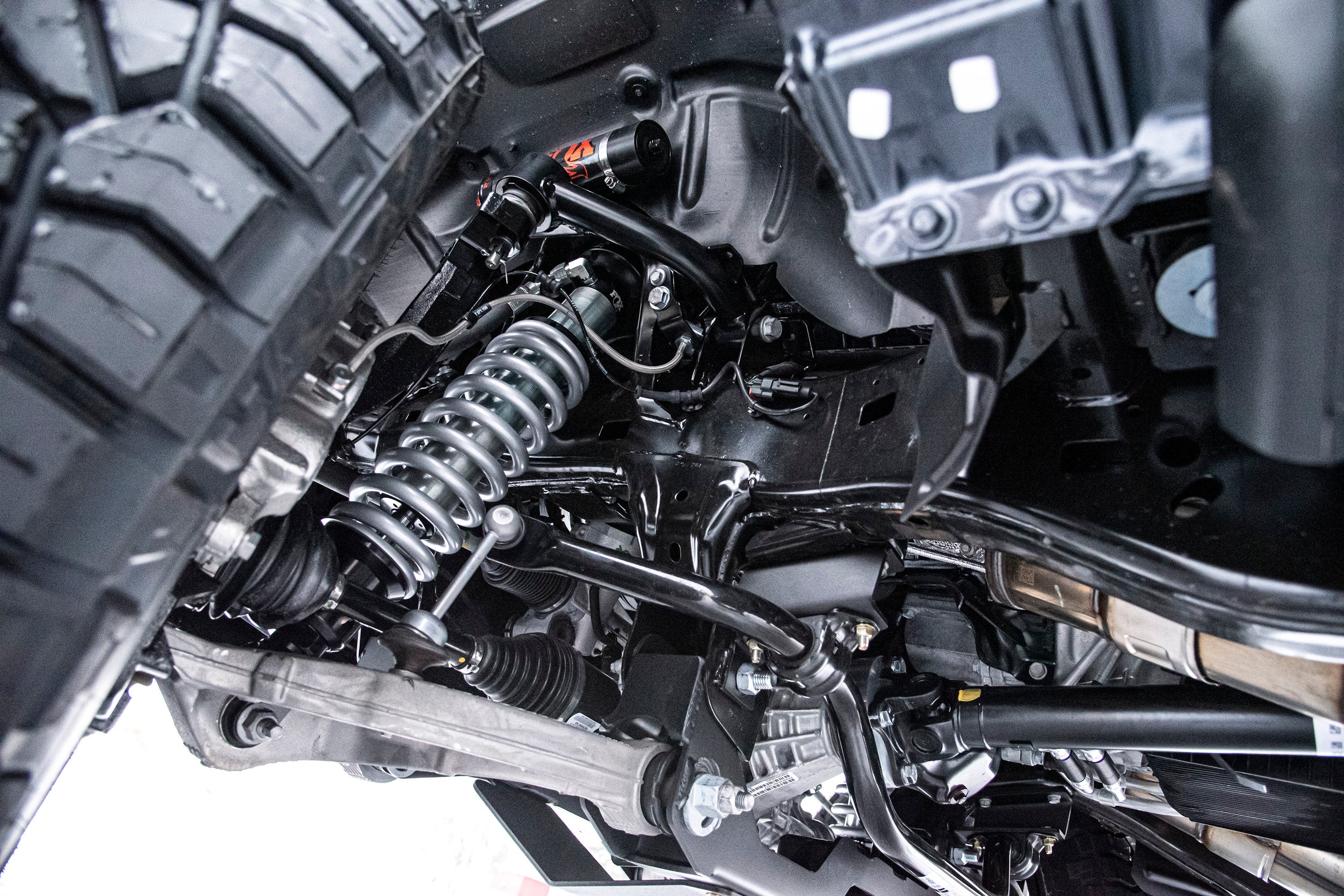 6-inch lift kit with FOX 2.5 Performance Elite coil-over installed on a Ram 1500 4WD, showcasing suspension components.