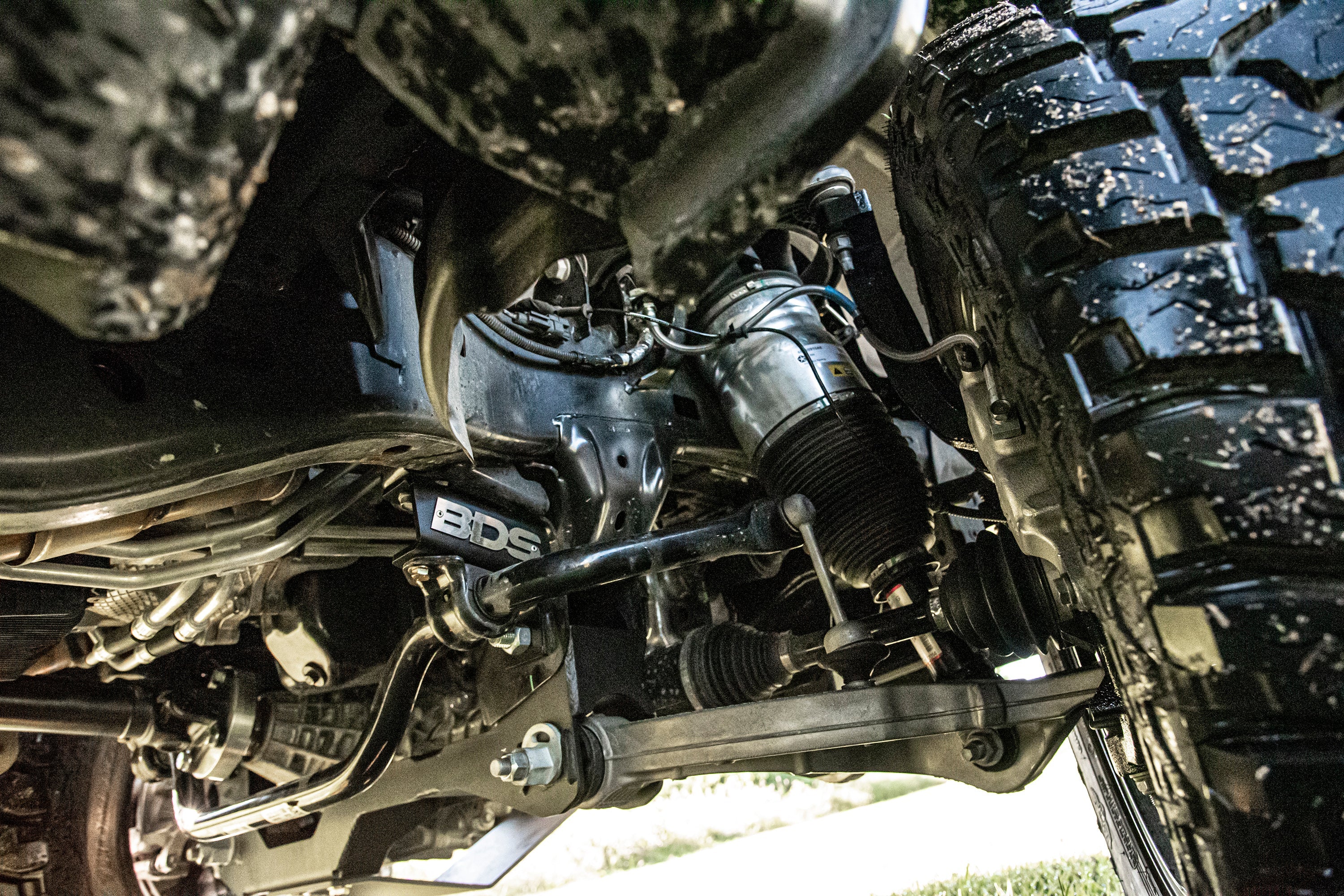 4-inch lift kit for 2019-2024 Ram 1500 with air ride, showcasing suspension components and rugged tire tread.