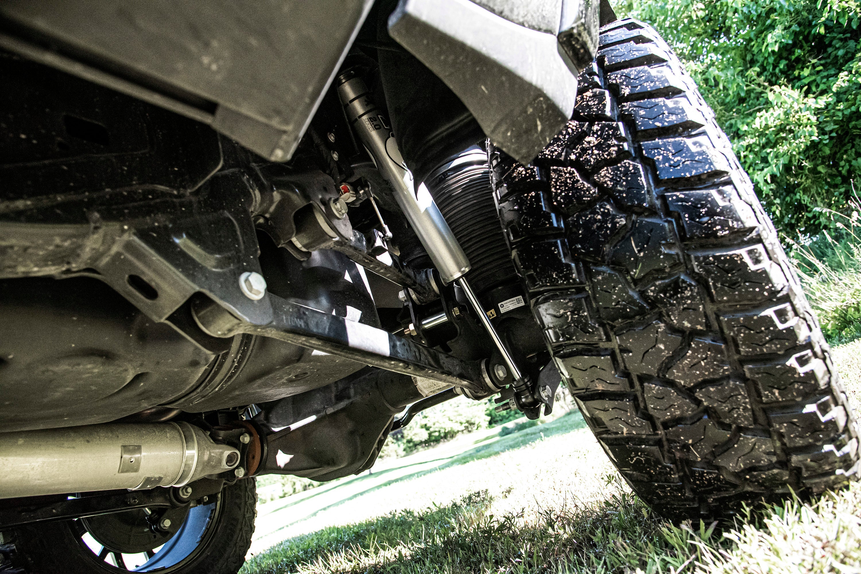 4 inch lift kit installed on a Ram 1500 with air ride, showcasing suspension and rugged tire details.