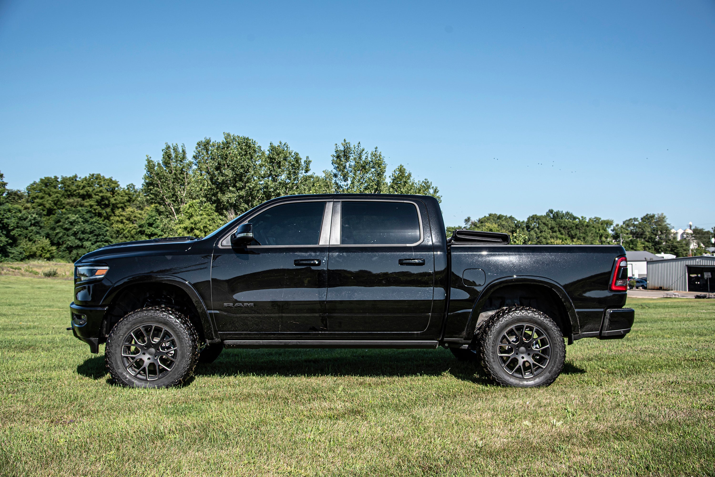 4-inch lift kit installed on a black Ram 1500 4WD truck, showcasing enhanced height and off-road capability.