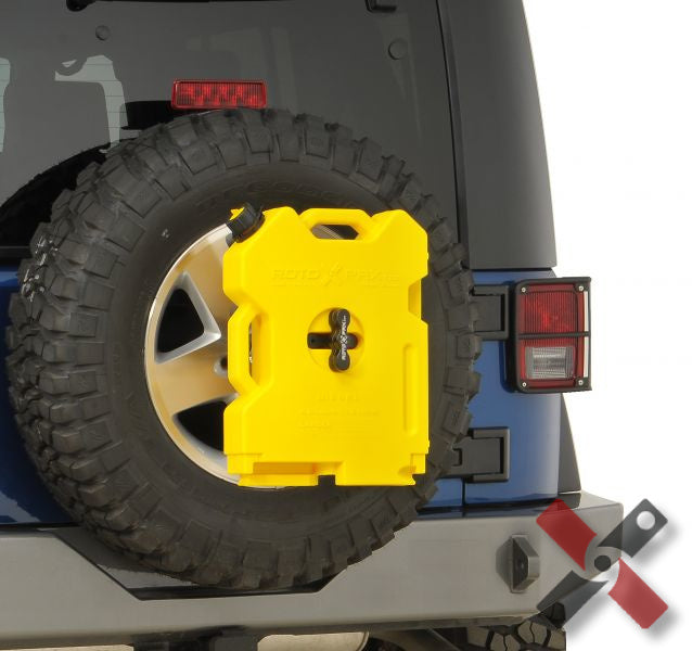 Yellow 2-gallon Rotopax diesel fuel container mounted on the spare tire of a blue offroad vehicle.