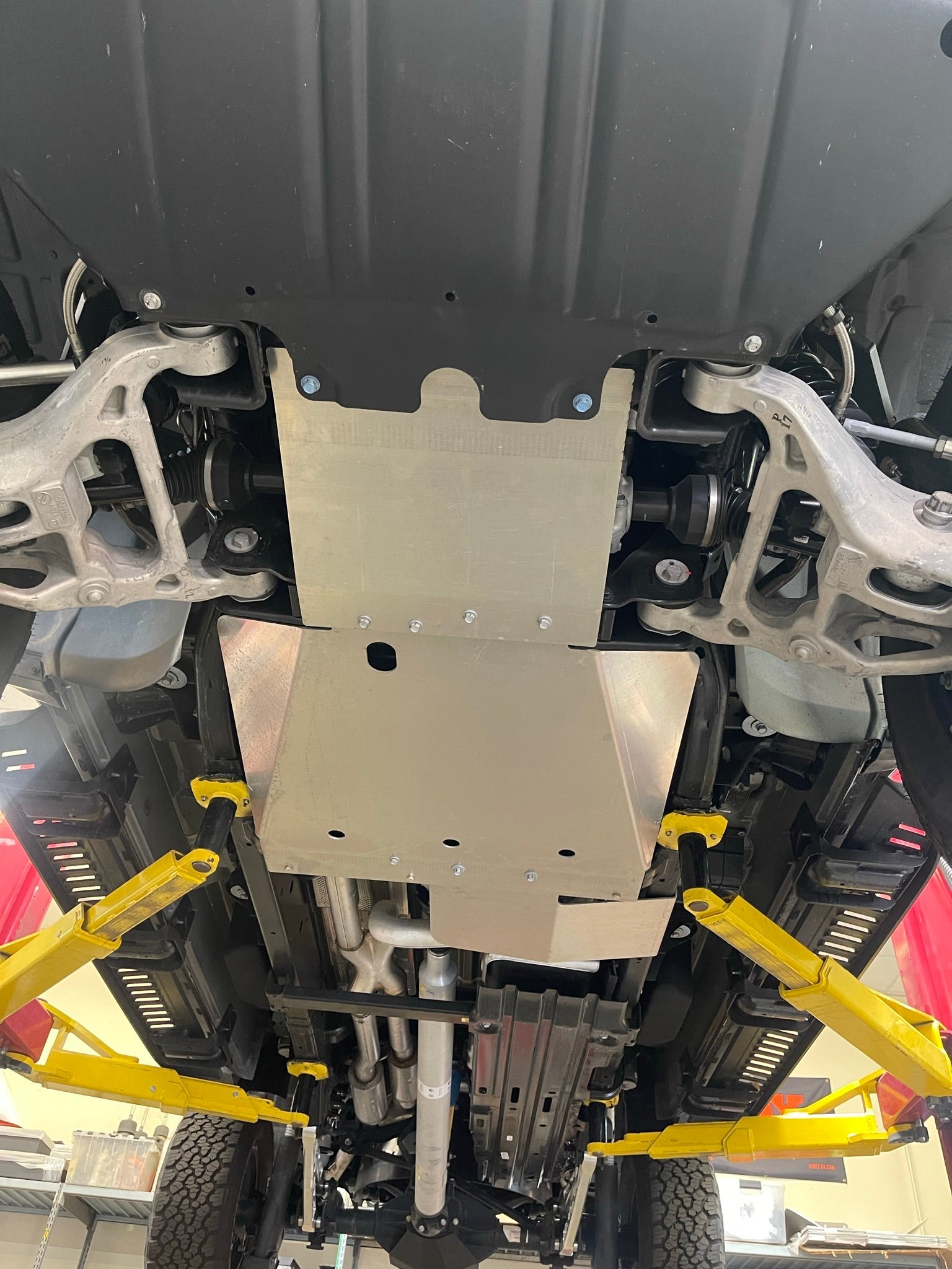 Underbody view of a 2021-2024 Ram TRX featuring a skid plate kit, showcasing robust protection for off-road use.