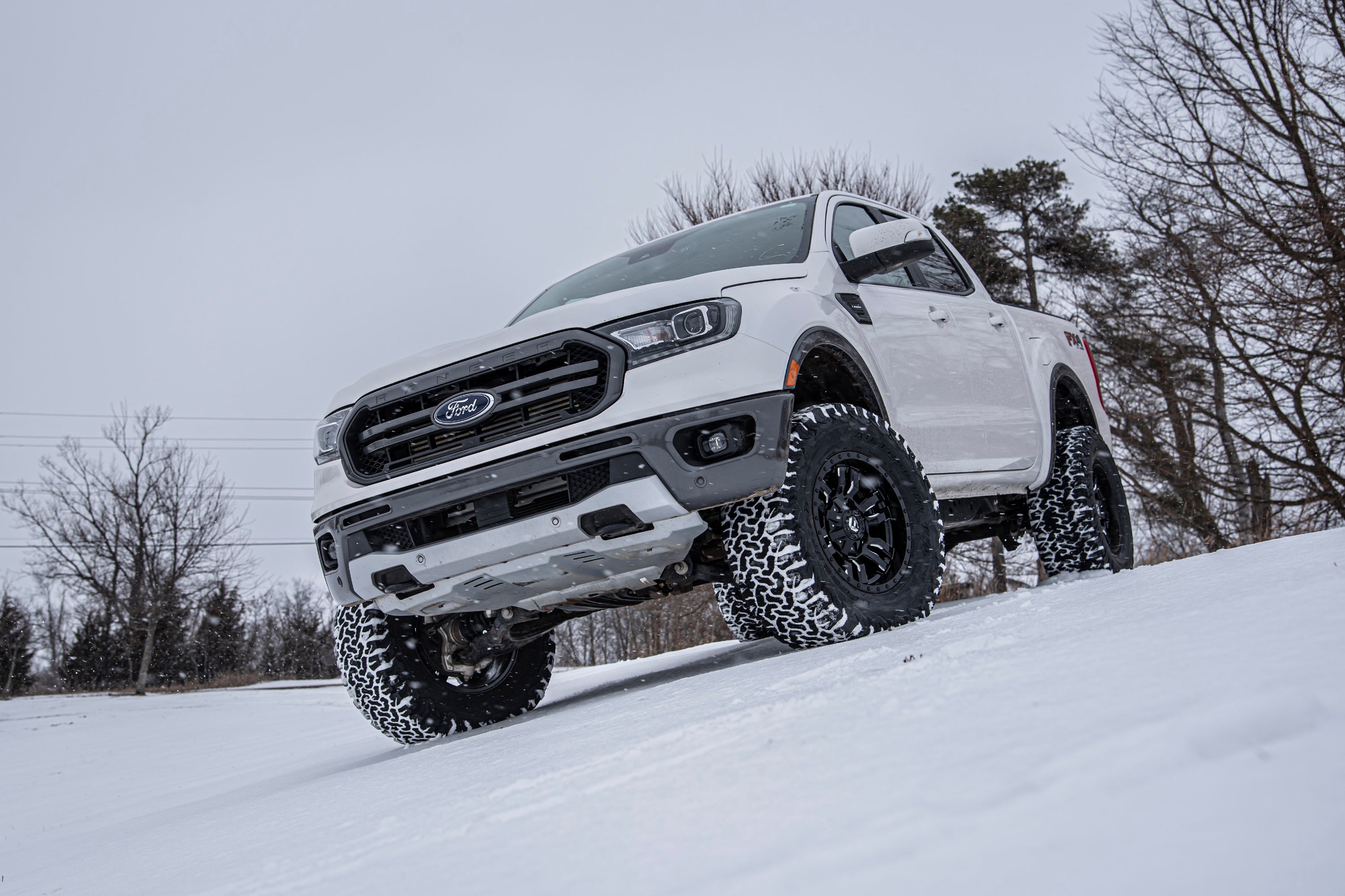 3.5 inch lift kit with FOX 2.0 coil-over installed on a white Ford Ranger 4WD driving on snow-covered terrain.