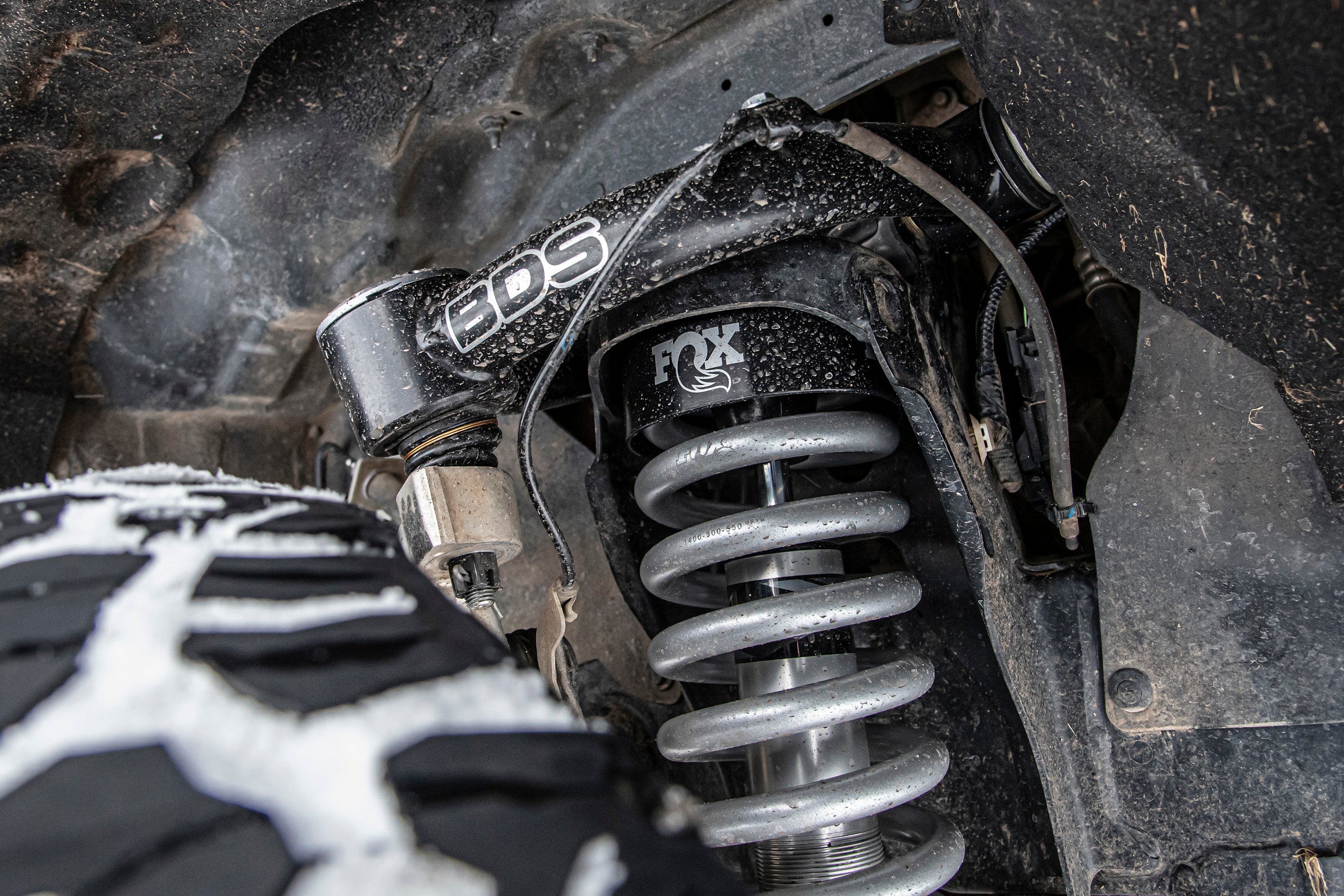 Close-up of a 3.5 inch lift kit installed on a Ford Ranger 4WD, featuring BDS components and Fox shocks for enhanced off-road performance.