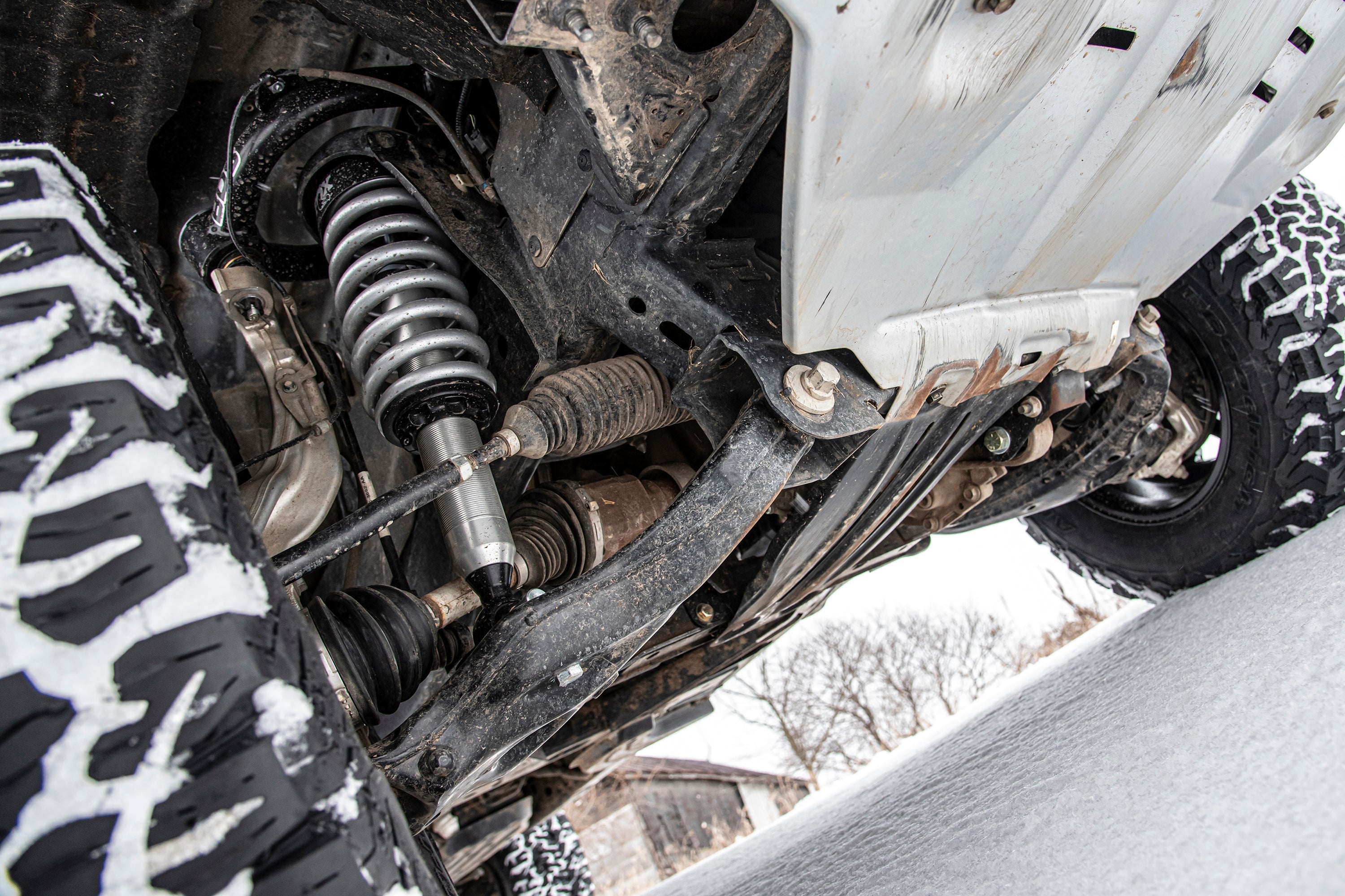 3.5 inch lift kit installed on a Ford Ranger 4WD, showcasing suspension components and rugged tires in a snowy environment.
