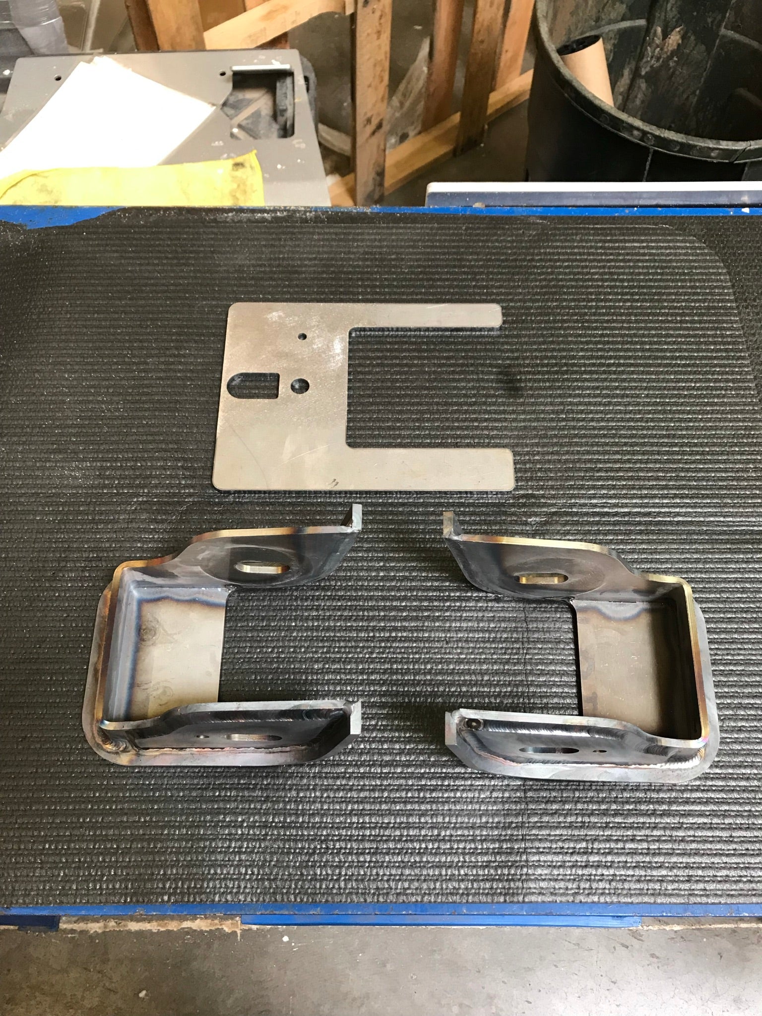 Lower arm pocket replacement kit for 2017-2024 Raptor by Foutz Motorsports, featuring metal components on a textured surface.