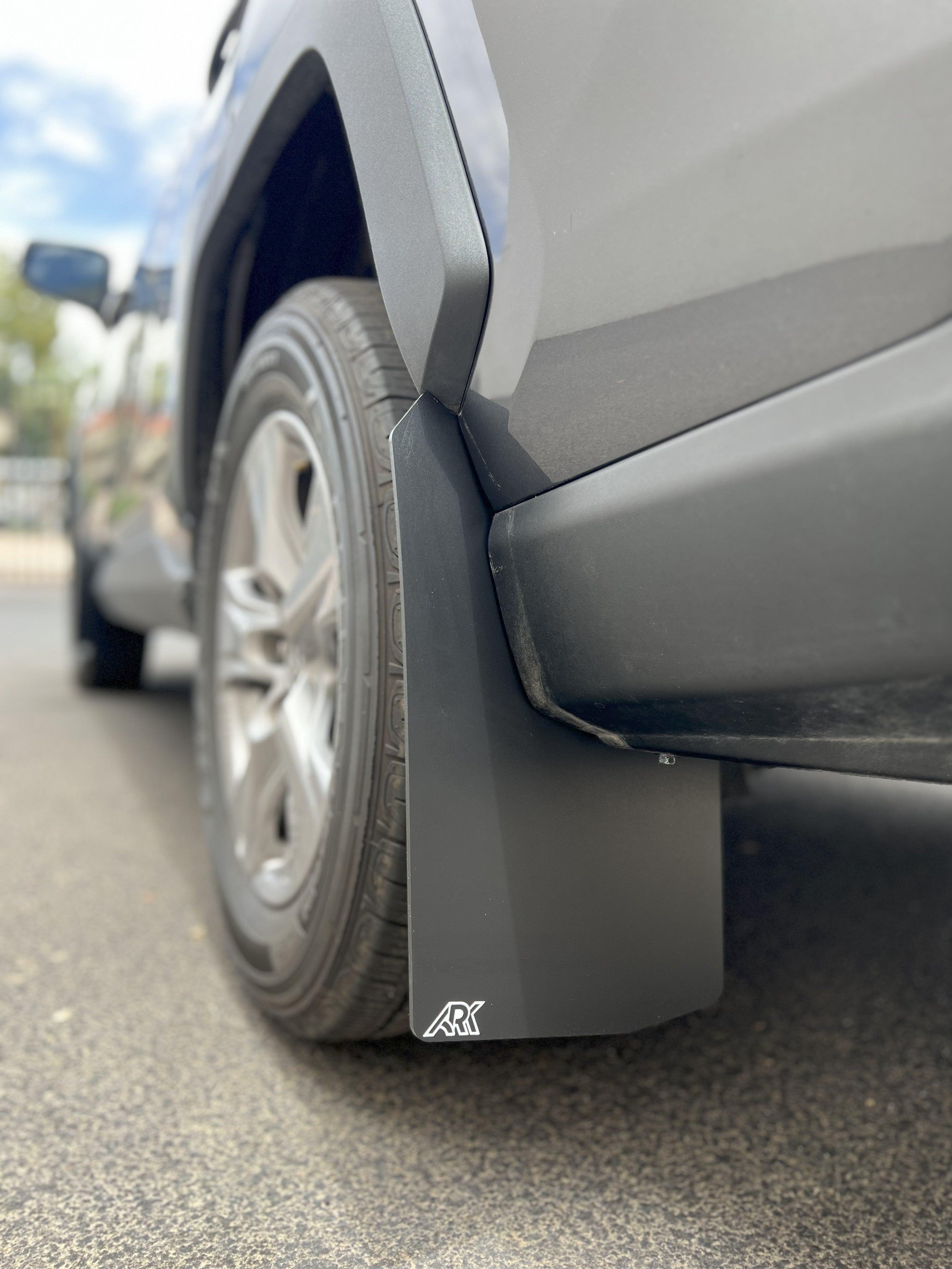 TriXPoly mudflaps for 2019-2025 Toyota RAV4 Gen 5, designed for protection and durability, mounted on a vehicle's rear wheel.