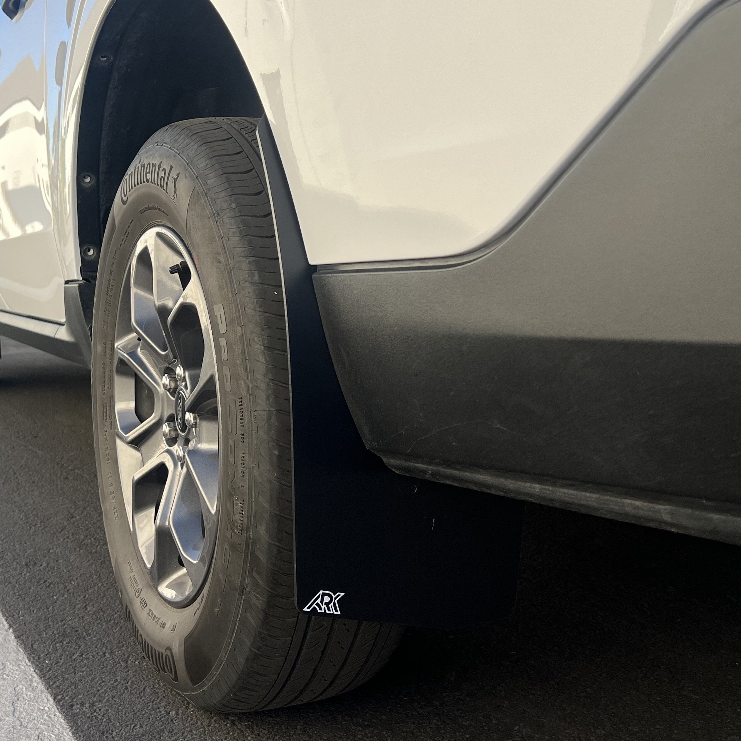2022+ Ford Maverick mud flaps installed on a vehicle, showcasing protection against mud and debris.