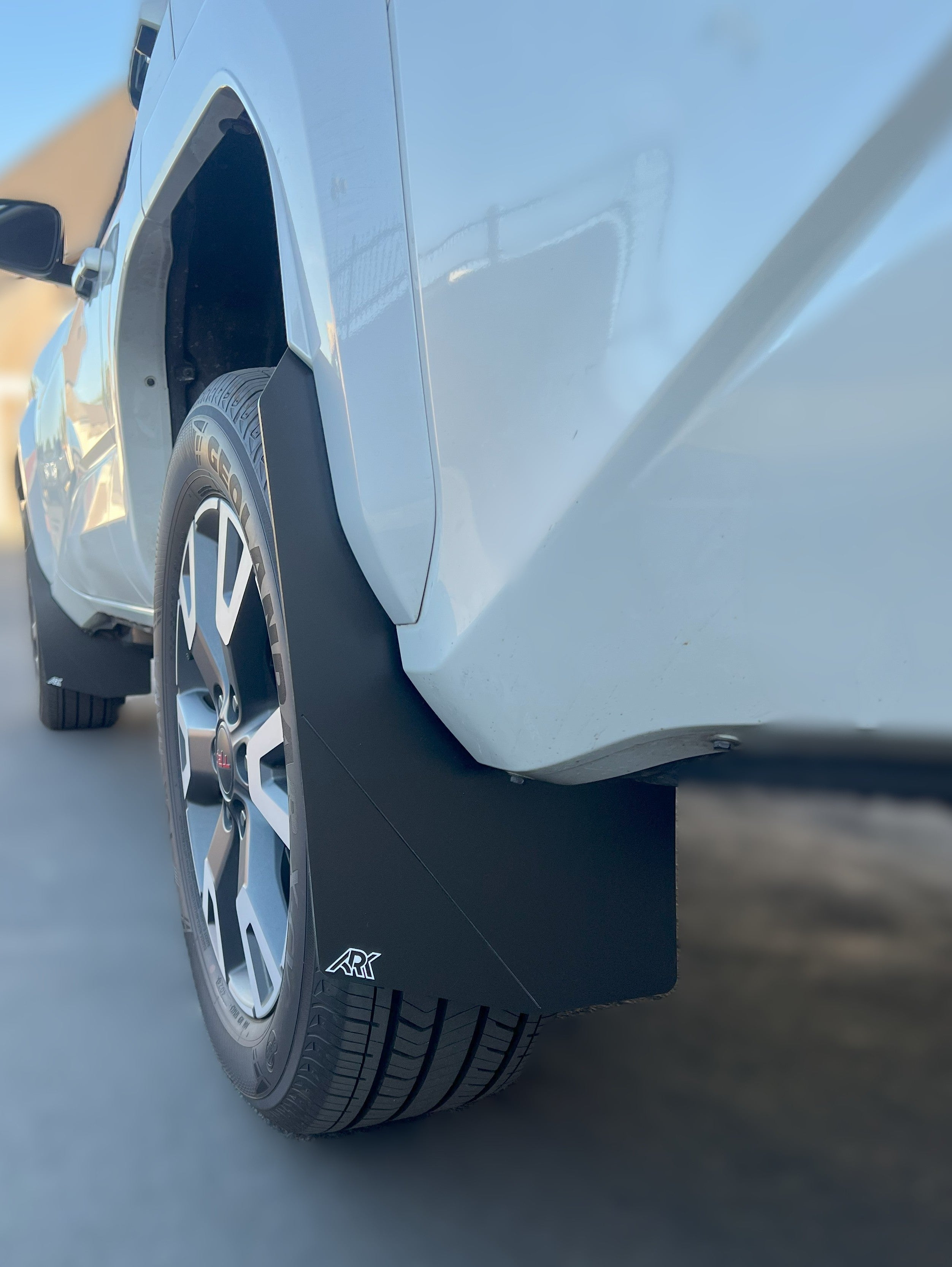 2025+ Toyota 4Runner TriXpoly Mudflaps installed on a white vehicle, providing protection against mud and debris.