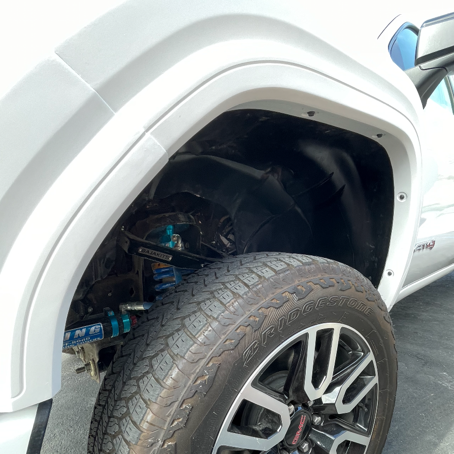 2019-2025 GMC Sierra fender showcasing wheel well and suspension components for enhanced offroad performance.