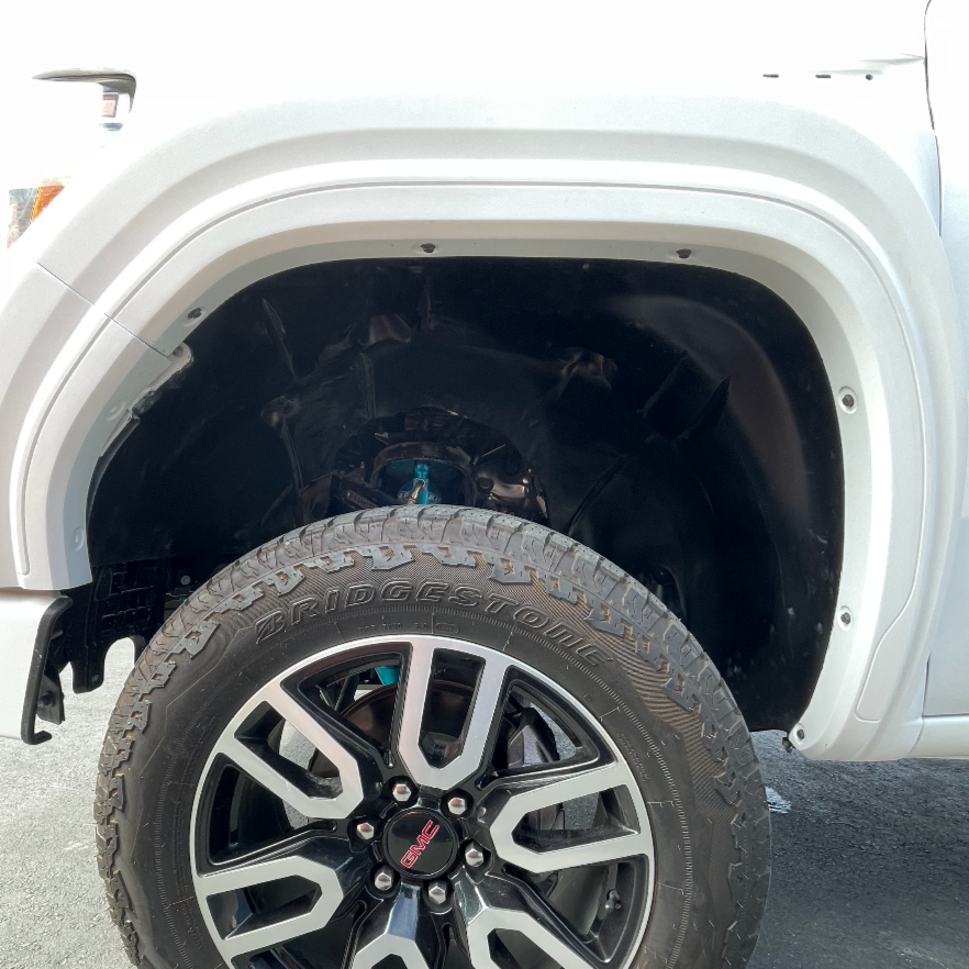 2019-2025 GMC Sierra fender showcasing wheel well and tire, designed for enhanced offroad performance and style.