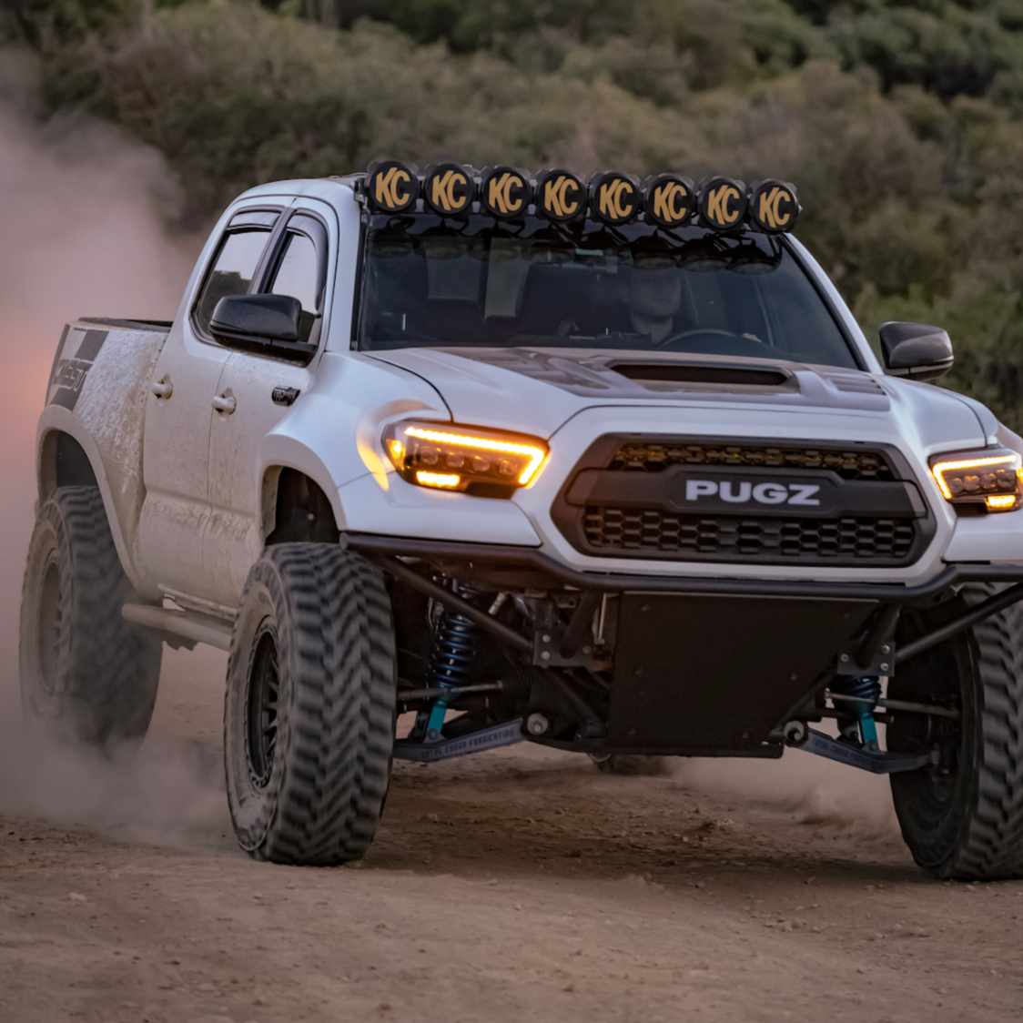 2016-2023 Toyota Tacoma fenders on a modified truck driving off-road, showcasing rugged design and enhanced performance.