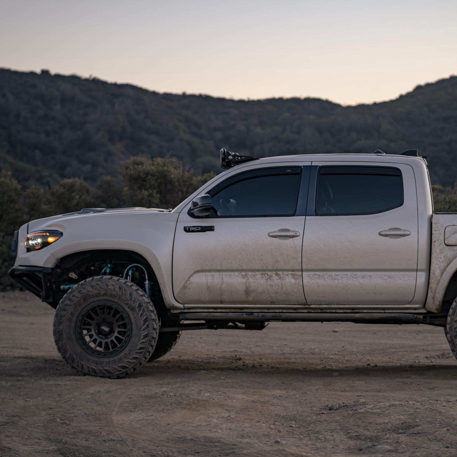 2016-2023 Toyota Tacoma with offroad fenders, showcasing rugged design and enhanced tire clearance in a natural setting.