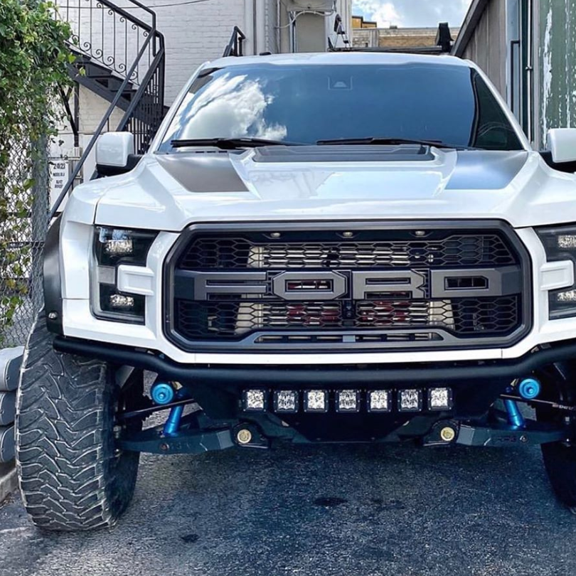 2017-2020 Ford Raptor with custom fenders showcasing an aggressive front design and off-road lighting.