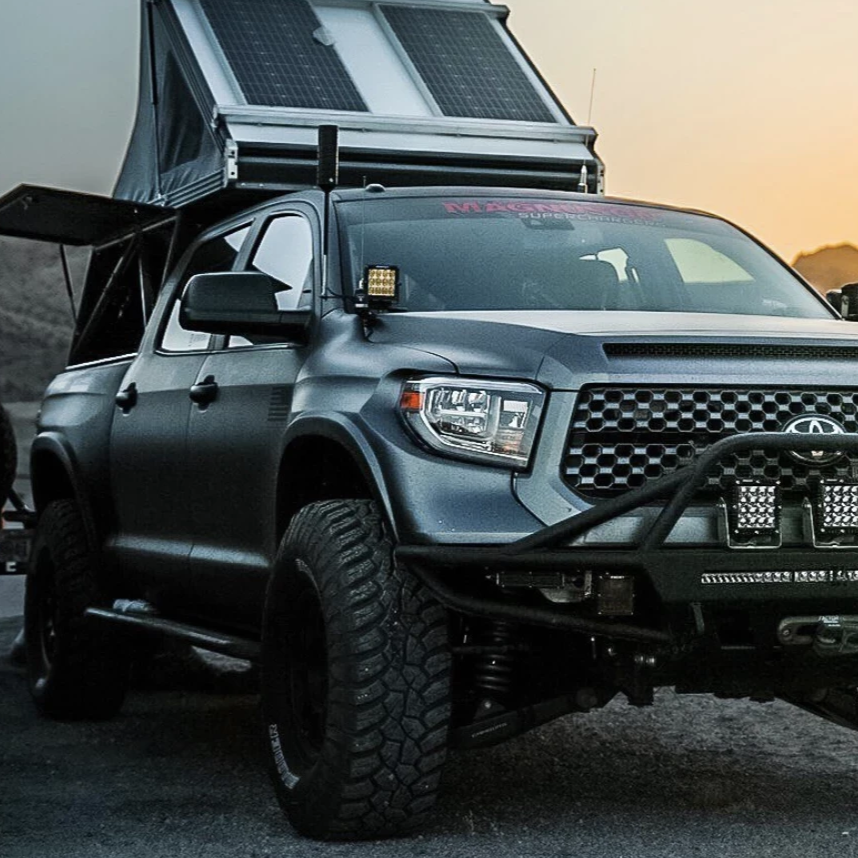 2014-2021 Toyota Tundra fenders showcased on a modified truck with offroad features and a rooftop tent.