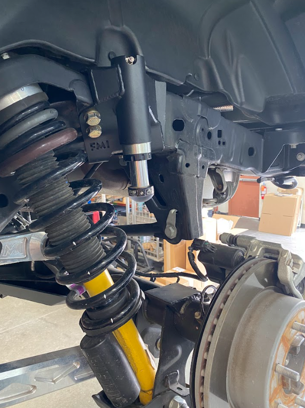 2021 and up Bronco rear hydraulic bump stop kit installed, showcasing suspension components and mounting details.