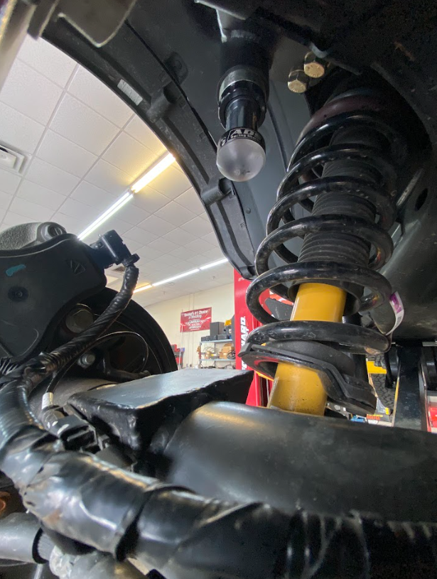 2021 and up Bronco rear hydraulic bump stop kit installed, showcasing suspension components and bump stop location.