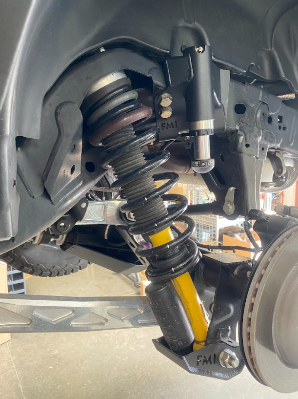 2021 and up Bronco rear hydraulic bump stop kit installed, showcasing suspension components and shock absorber setup.