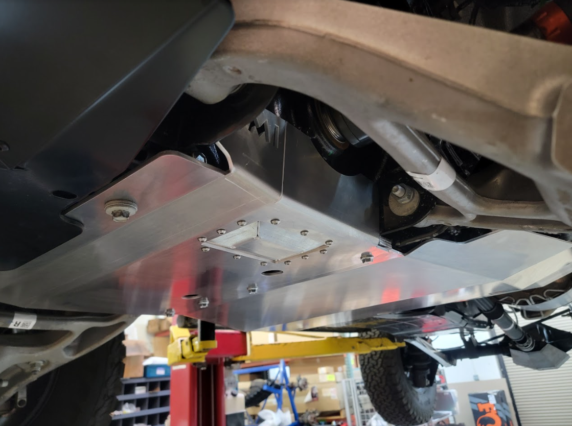 Aluminum skid plate installed on a 2022 Ford Bronco Raptor, providing undercarriage protection for off-road use.