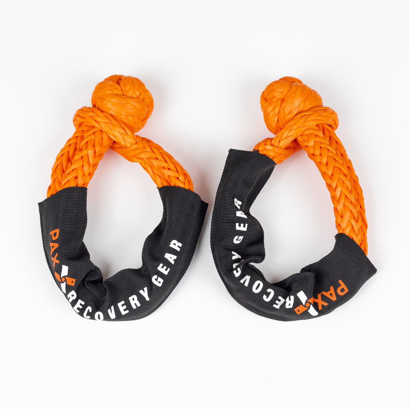 Durable 1/2-inch soft shackles designed for offroad recovery, featuring bright orange rope and protective black sleeves.