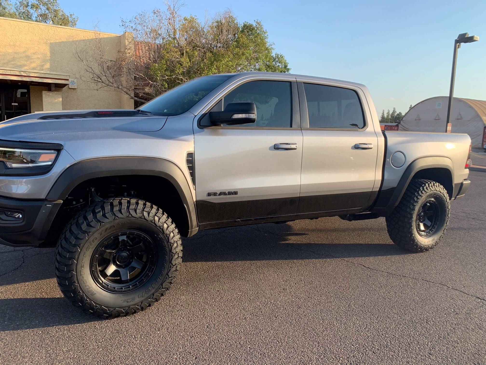 2025 Ram truck featuring a RHO 1.5 inch front leveling kit with offroad tires and a rugged stance.