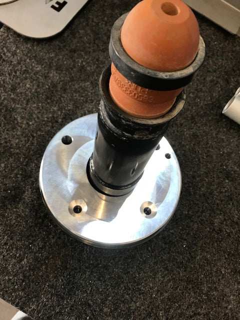 2021 and up Ram TRX rear spring spacer lift kit by Foutz Motorsports showcasing a metal spacer with rubber components.
