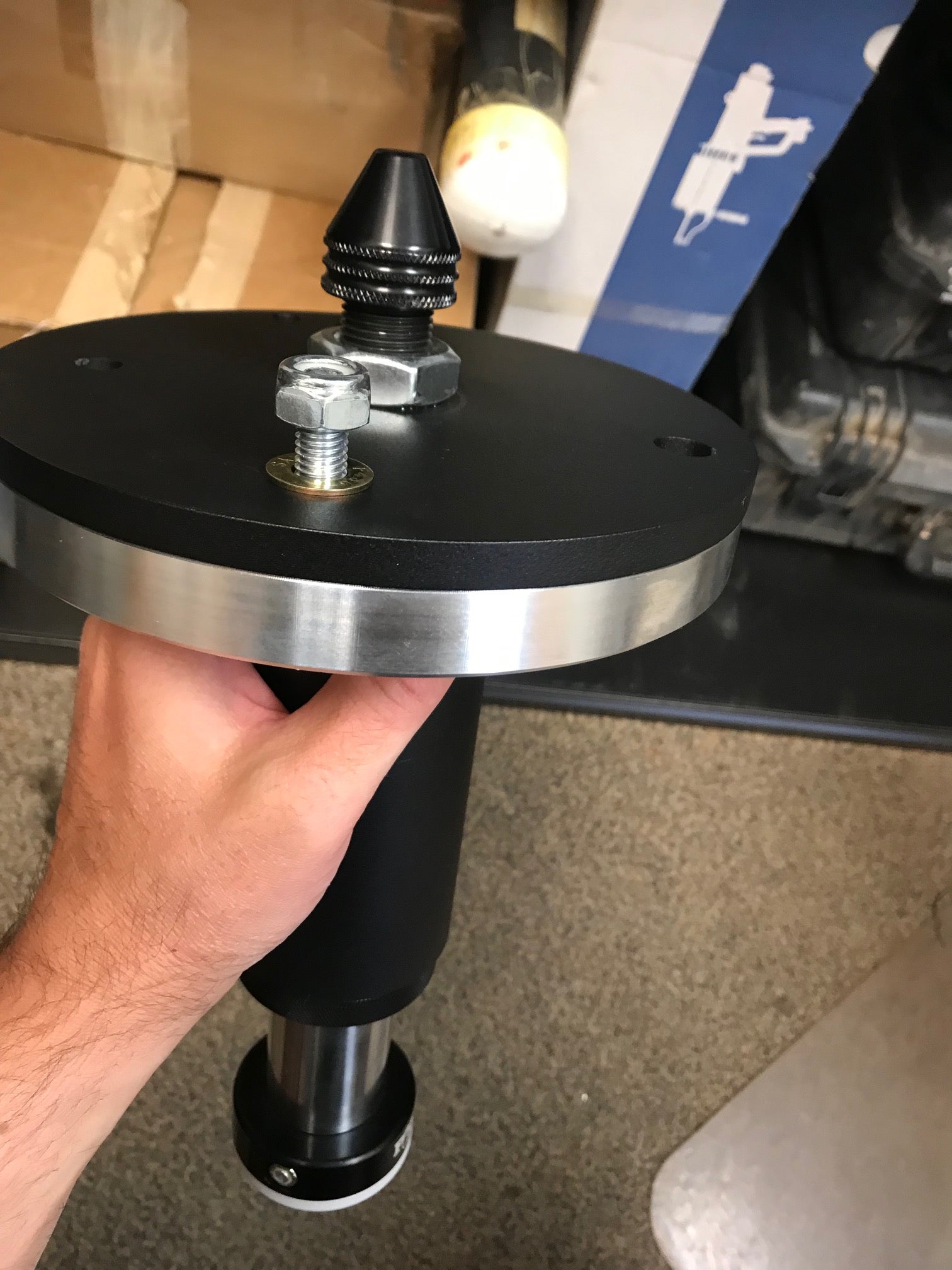 2021 and up Ram TRX rear spring spacer lift kit by Foutz Motorsports, showcasing a hand holding the spacer with hardware.