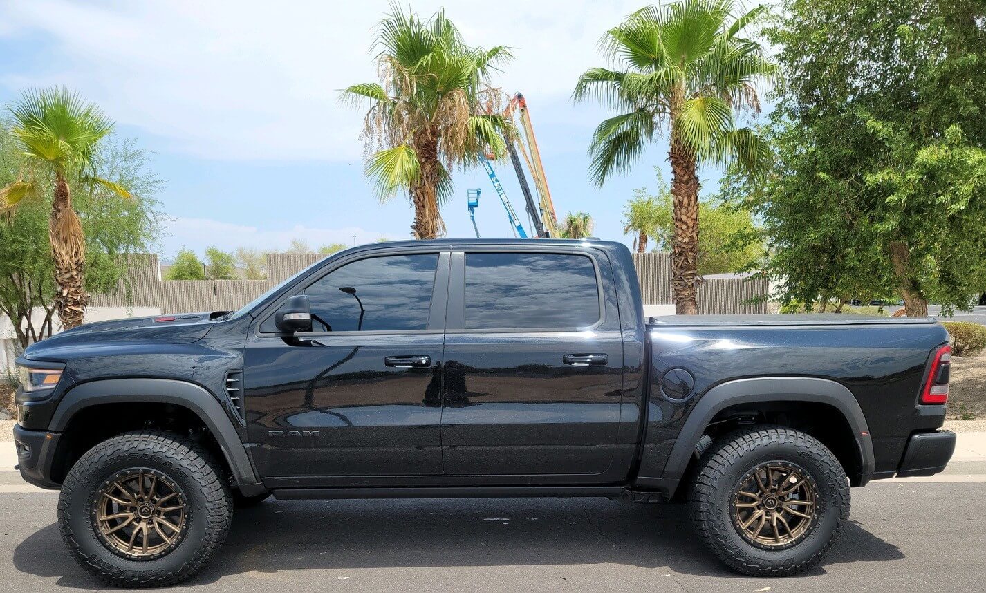 2025 Ram RHO 1.5 inch front leveling kit installed on a black Ram truck, showcasing enhanced stance and off-road capability.