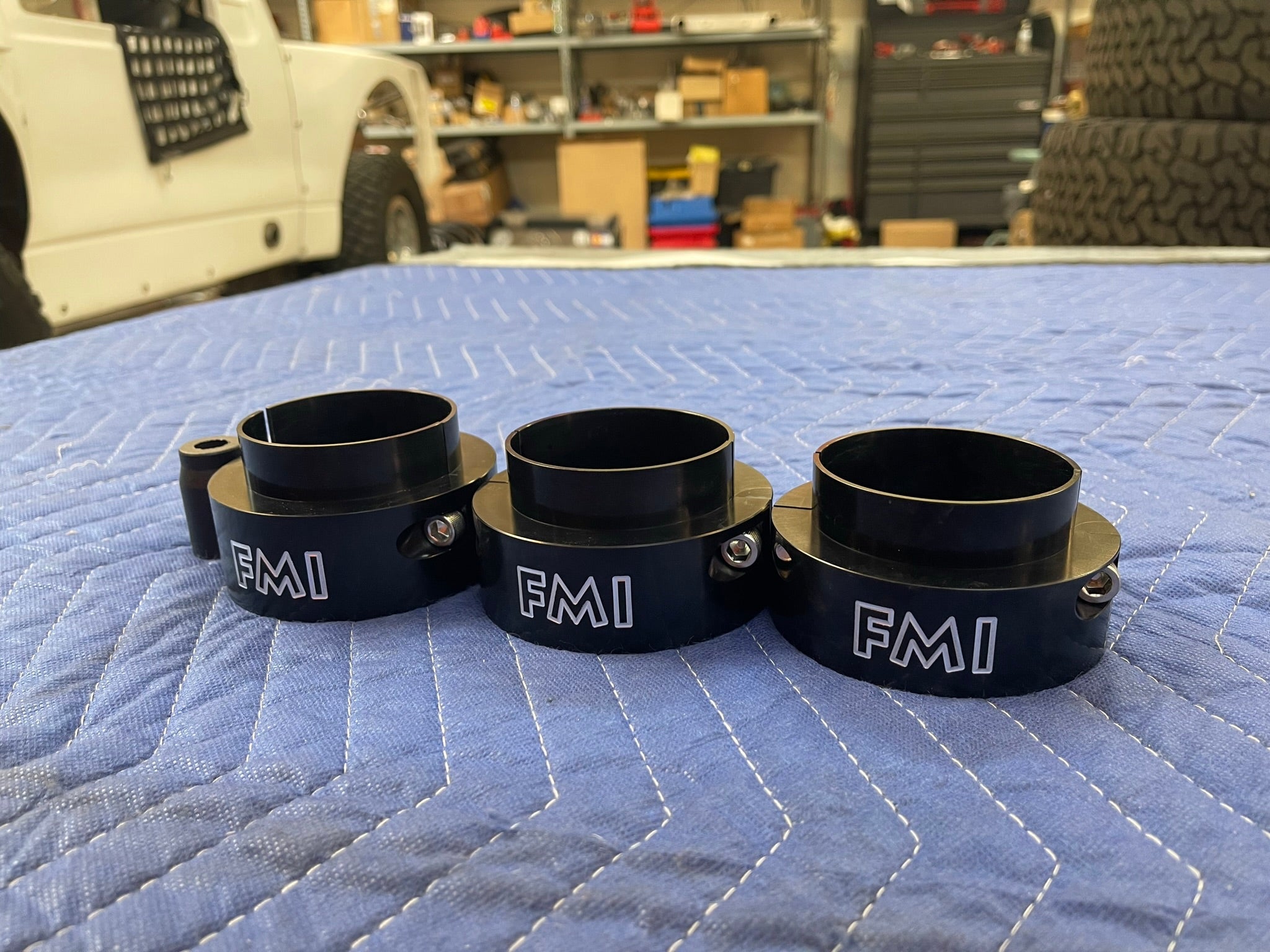 2021-2024 Ram TRX 2-inch front leveling kit featuring three black spacers with FMI branding, designed for enhanced offroad performance.
