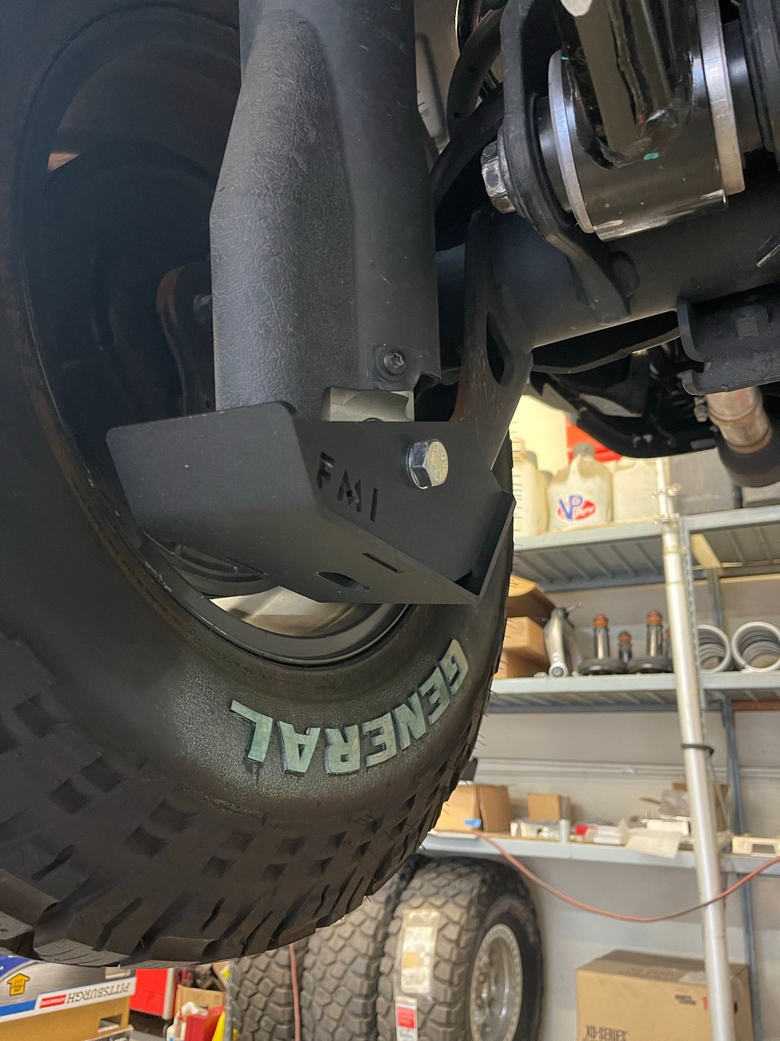 2025 Ram RHO Rear Shock Skid Kit installed on a truck's rear suspension, showcasing durable protection for offroad adventures.