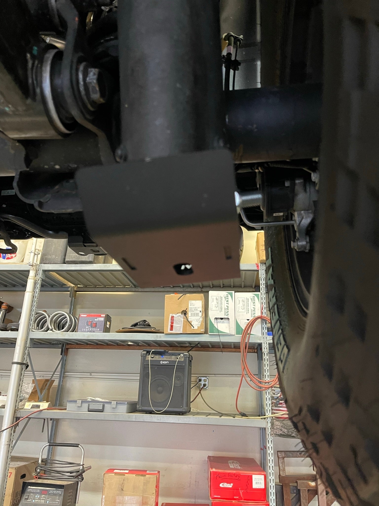 2025 Ram RHO Rear Shock Skid Kit installed under a vehicle, showcasing its durable design and protective features.