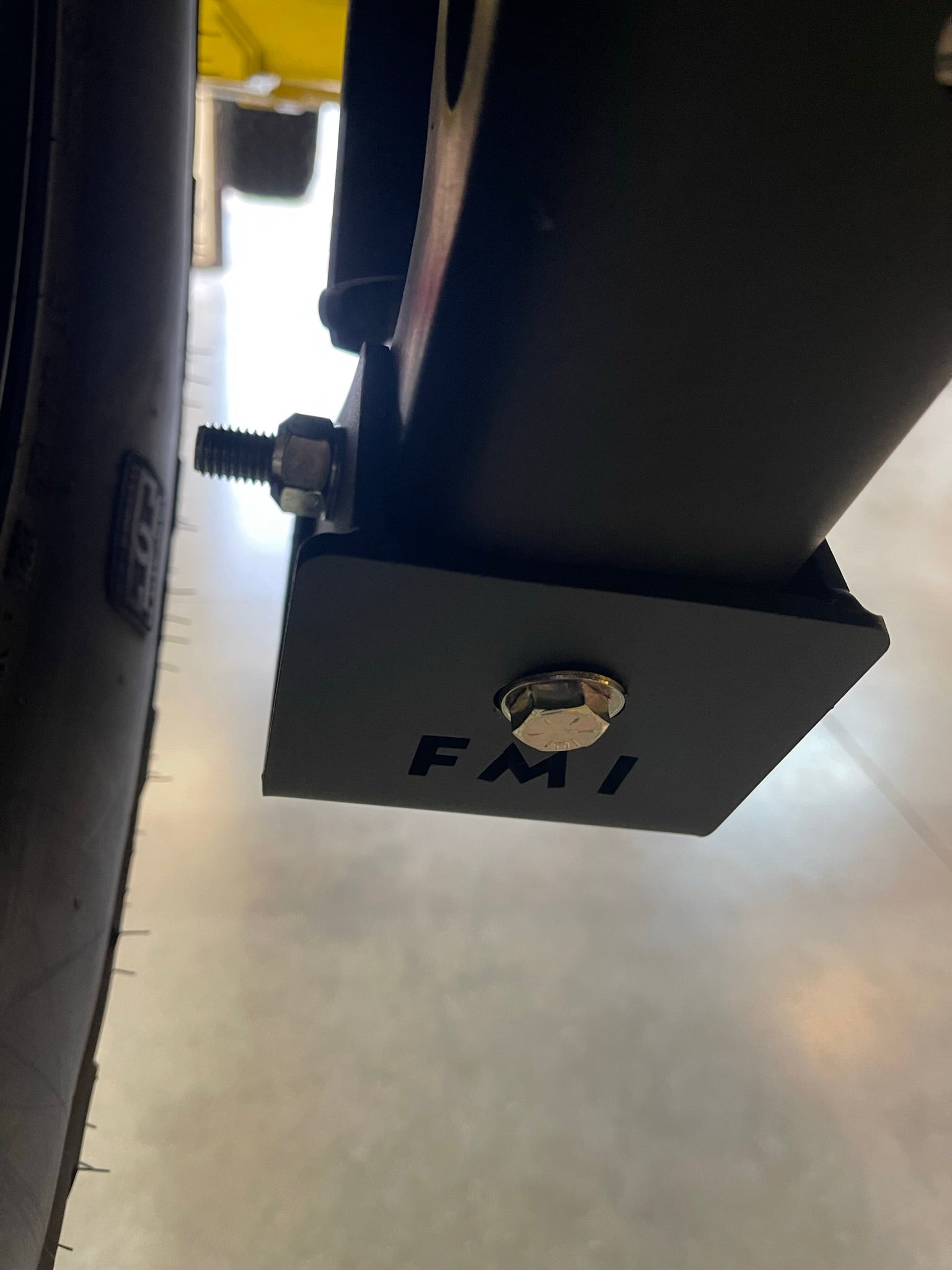 2025 Ram RHO Rear Shock Skid Kit showing a close-up of the mounting bracket and bolt, designed for offroad durability.