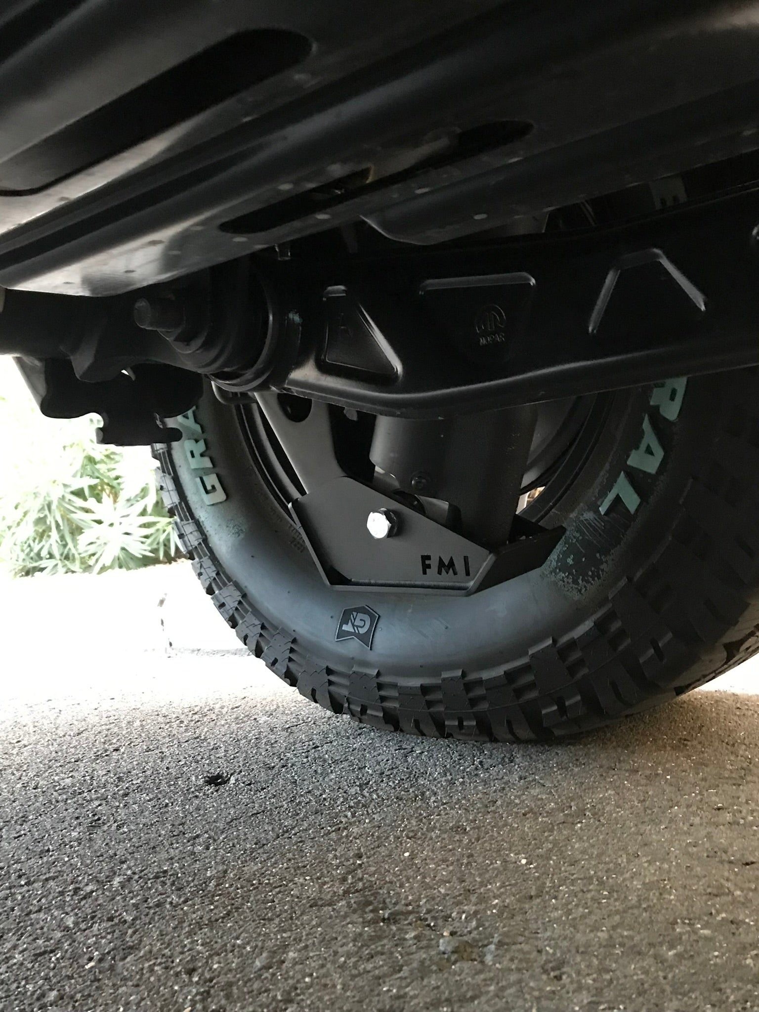 2025 Ram RHO Rear Shock Skid Kit installed under a truck, showcasing rugged protection and off-road capability.