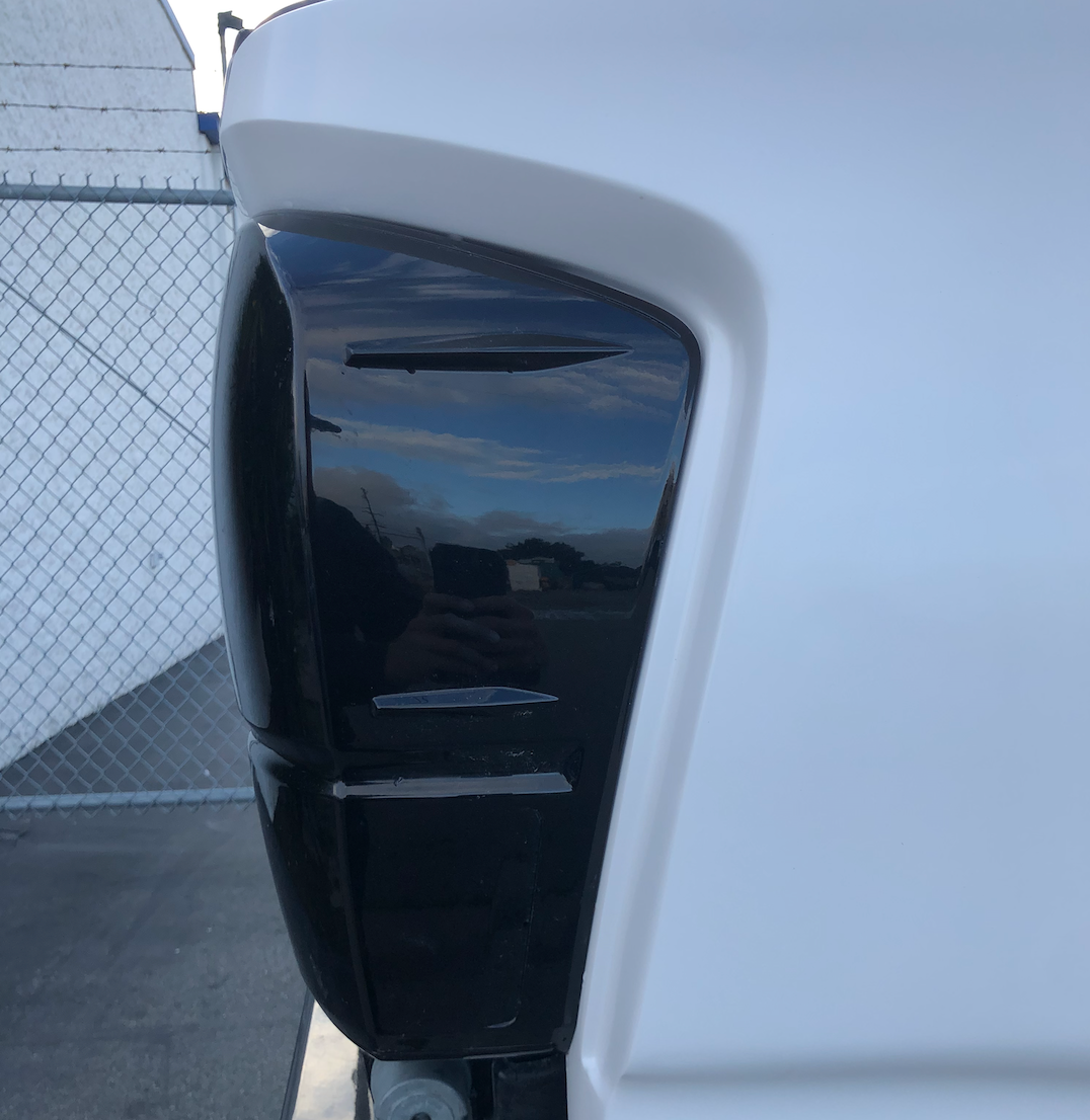 2016-2023 Toyota Tacoma bedsides showcasing a sleek design with a glossy black finish and smooth contours.