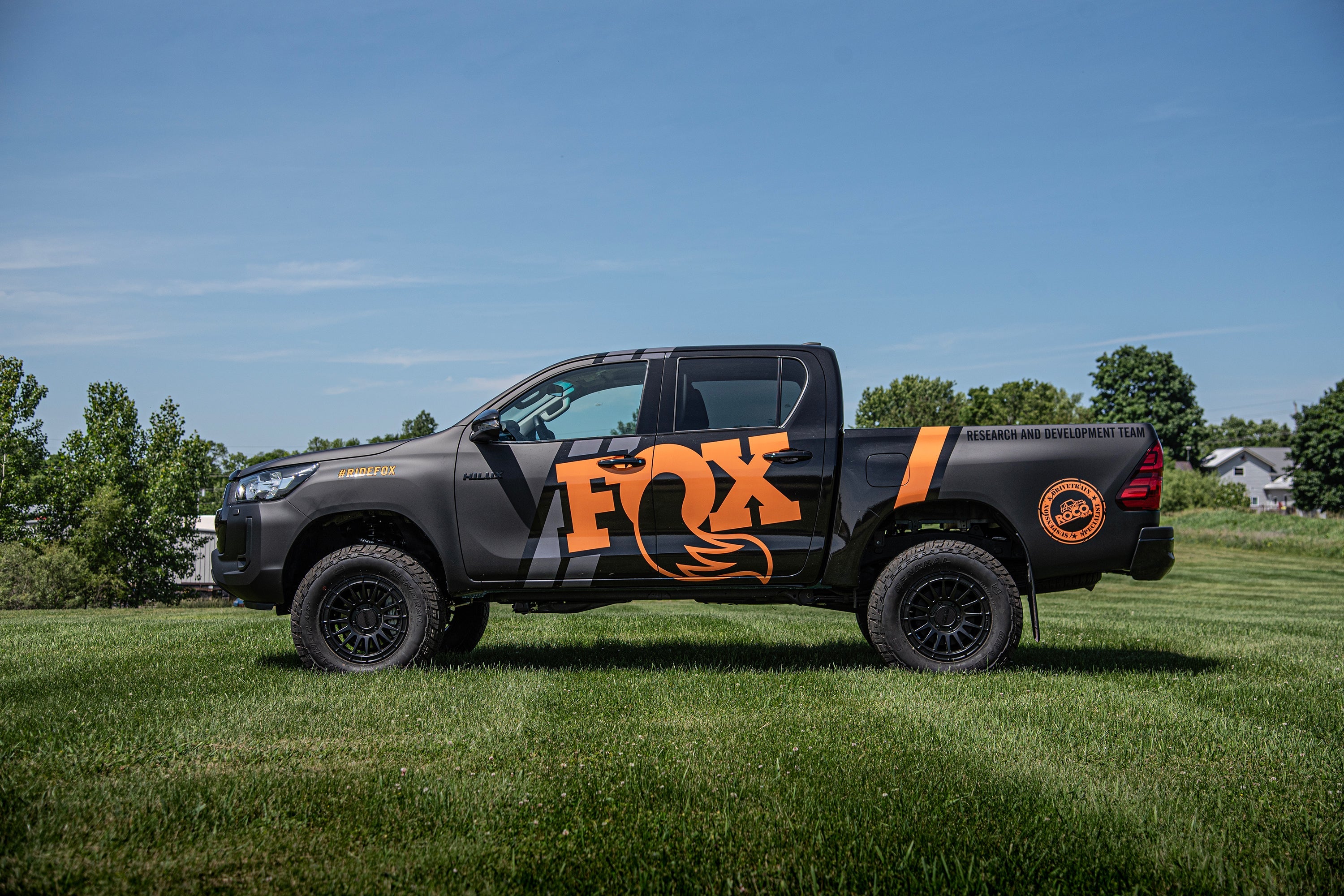 2 inch lift kit with FOX coil-overs installed on a Toyota Hilux, showcasing enhanced off-road capability and style.