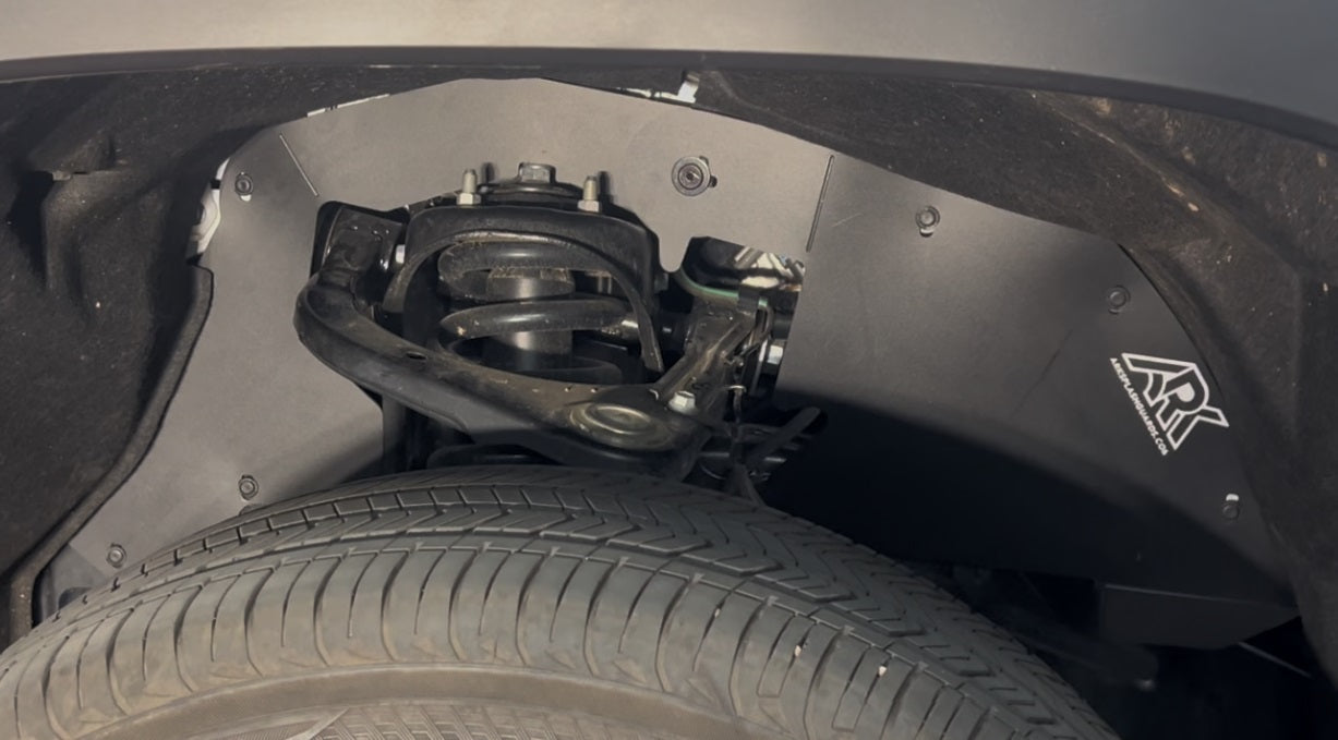 2022+ Toyota Tundra TriXpoly splash guards installed, protecting wheel well and suspension components from debris.