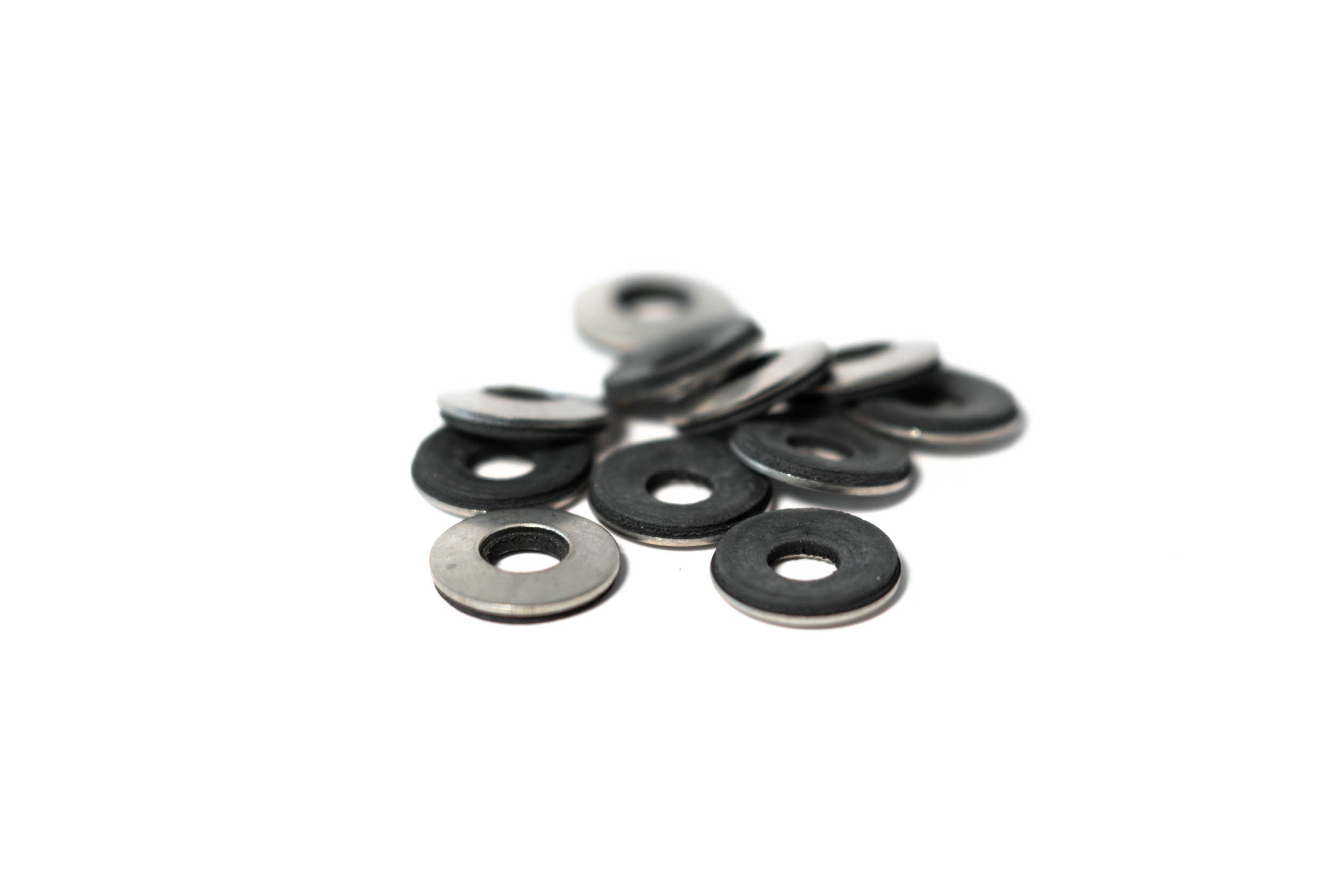 Bonded washers in various sizes, featuring a metal outer layer and rubber inner layer for effective sealing.