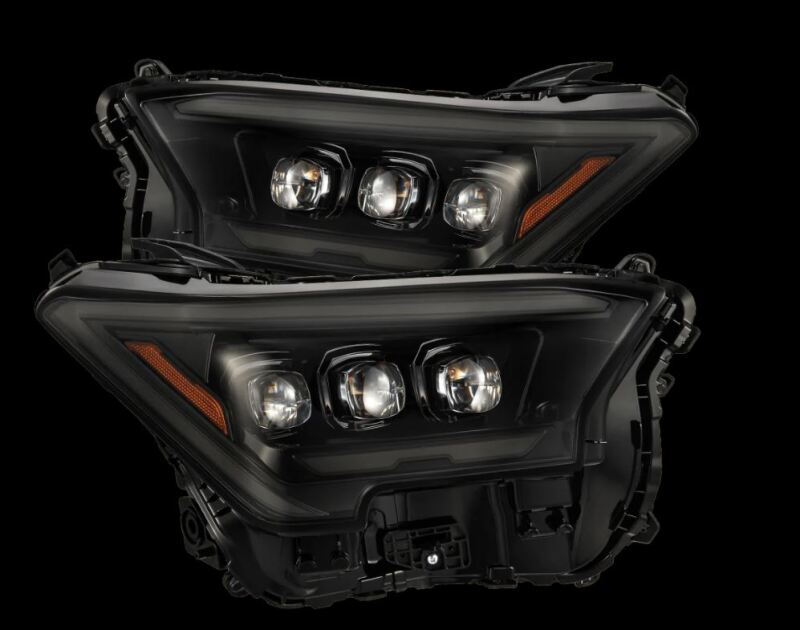 AlphaRex 2024 Toyota Tacoma NOVA-Series projector headlights in alpha-black with activation light, showcasing sleek design and advanced lighting.